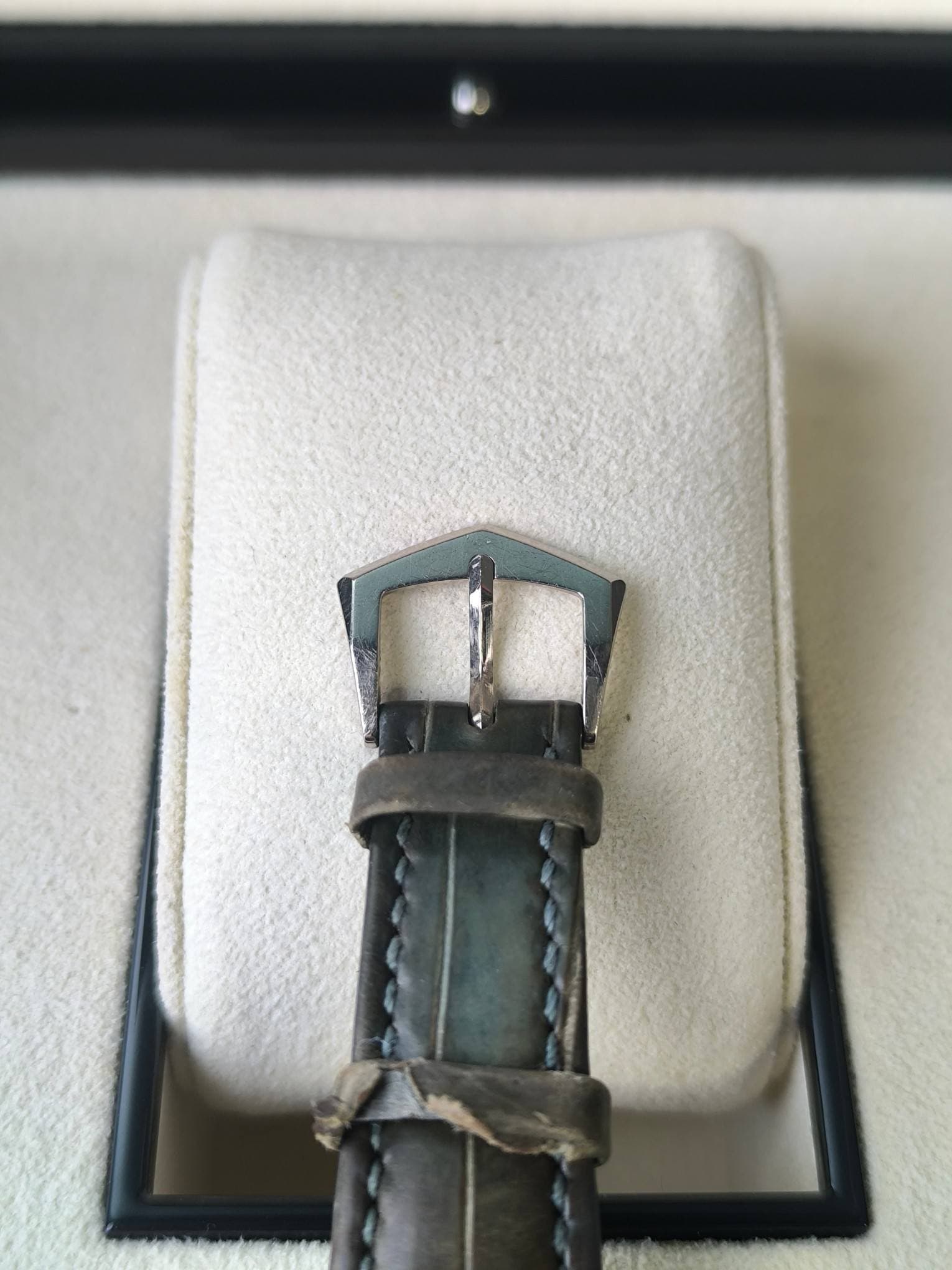 May be an image of wrist watch and saddle-stitched leather