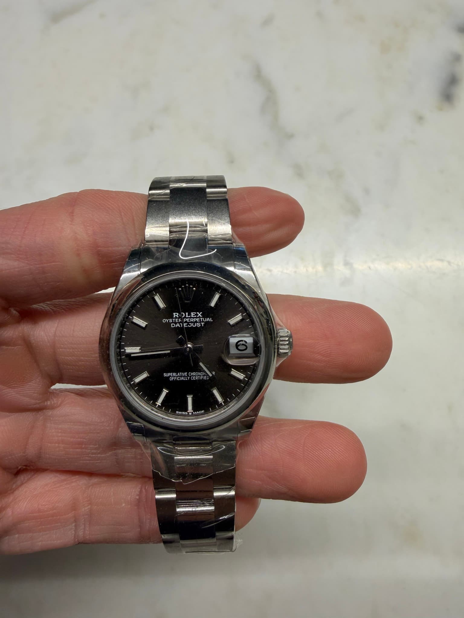 May be an image of wrist watch and text