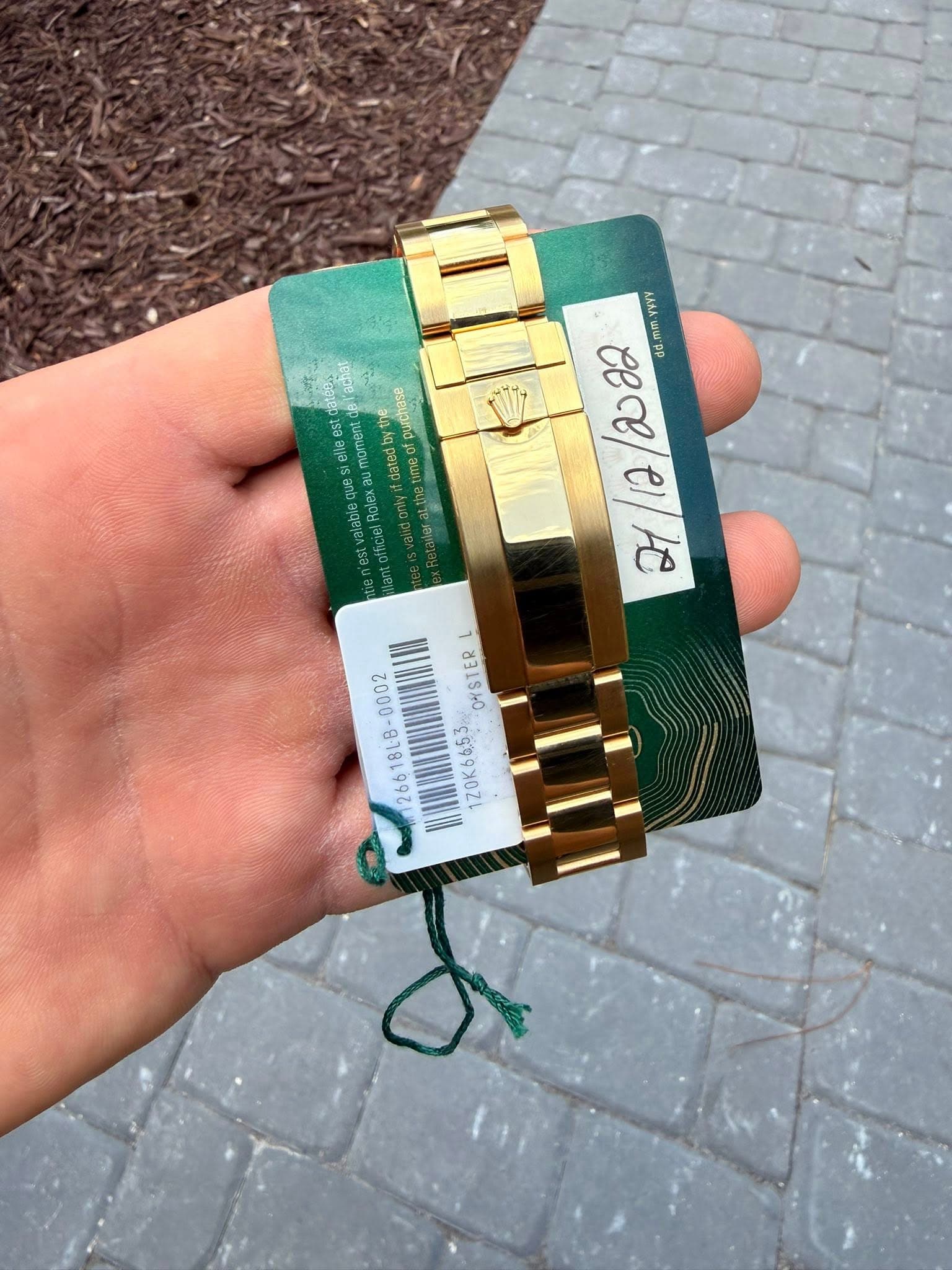 May be an image of lighter, wrist watch and text