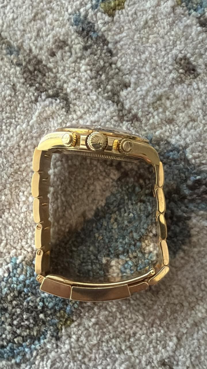 May be an image of wrist watch, jewelry and brass