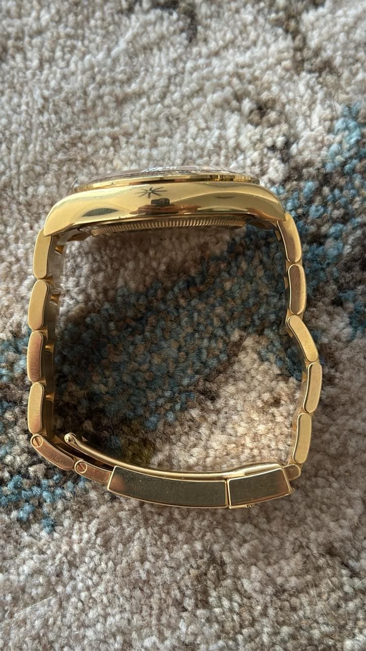 May be an image of brass, wrist watch and jewelry