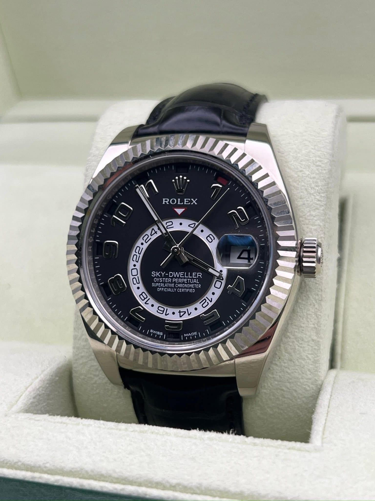 May be an image of wrist watch and text that says 'ROLEX E SKY-DWELLER OYSTERPERPETUAL SKY DWE DWELLER ER PERPETUAL FFICIALLY 18 VDAI oл CIALLYCERTIFIED CERTIFIED UAL TER TEP 16 14…