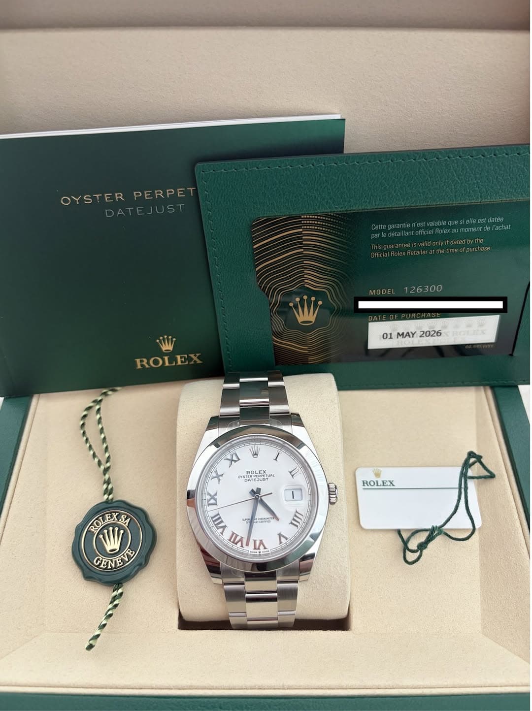 May be an image of wrist watch and text that says 'OYSTER OYSTERPERPE PERPE ATEJUST yifdstadyt MDDEL126300 MODEL 26300 ROLE 01 MAY 2026 PoLnX KOи XI BOL ROLEX STERPIUFETL EJUST…