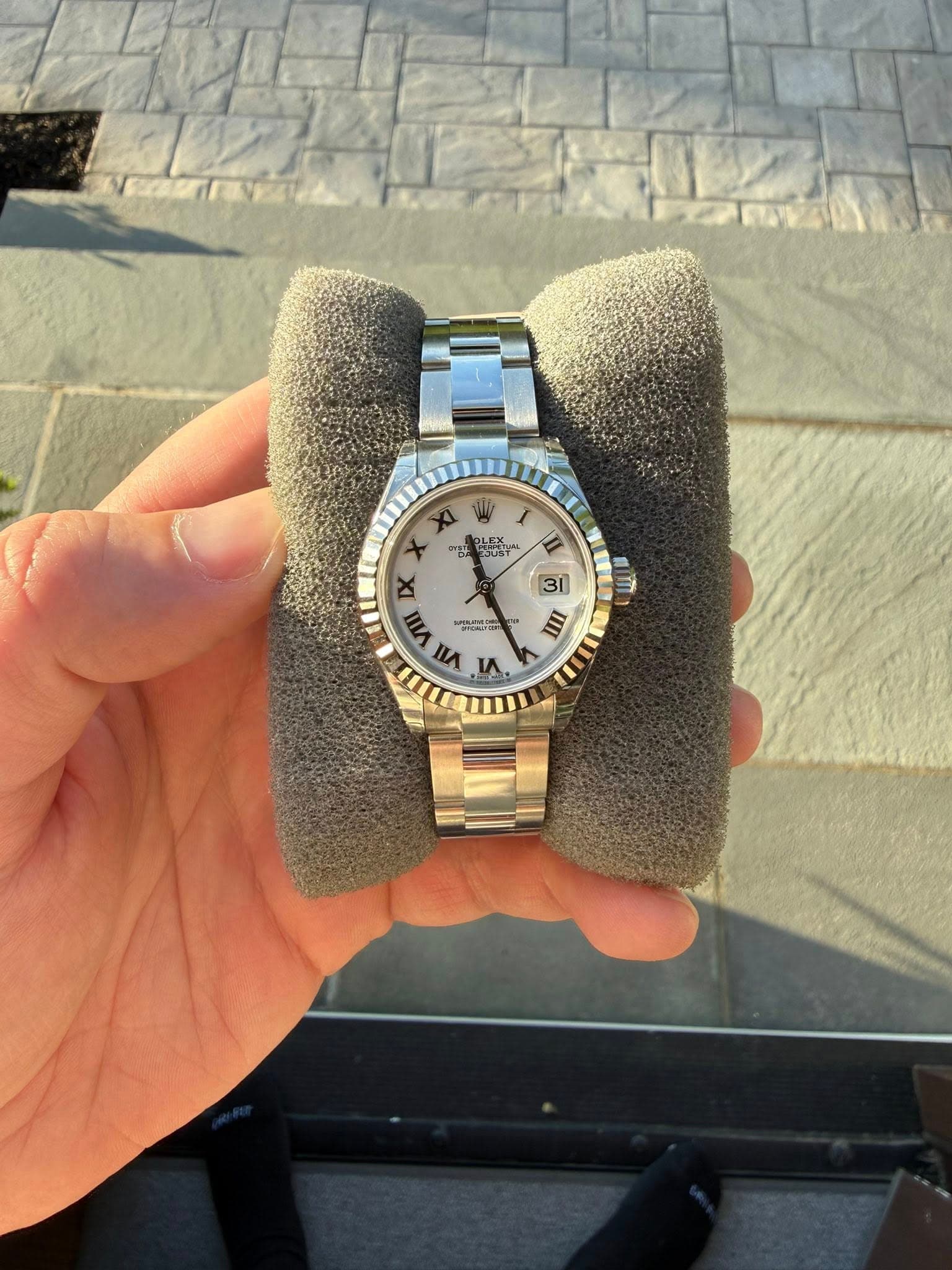 May be an image of wrist watch and text