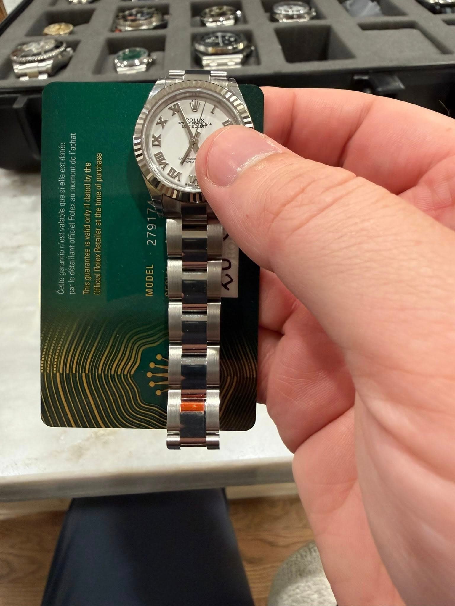 May be an image of wrist watch and text