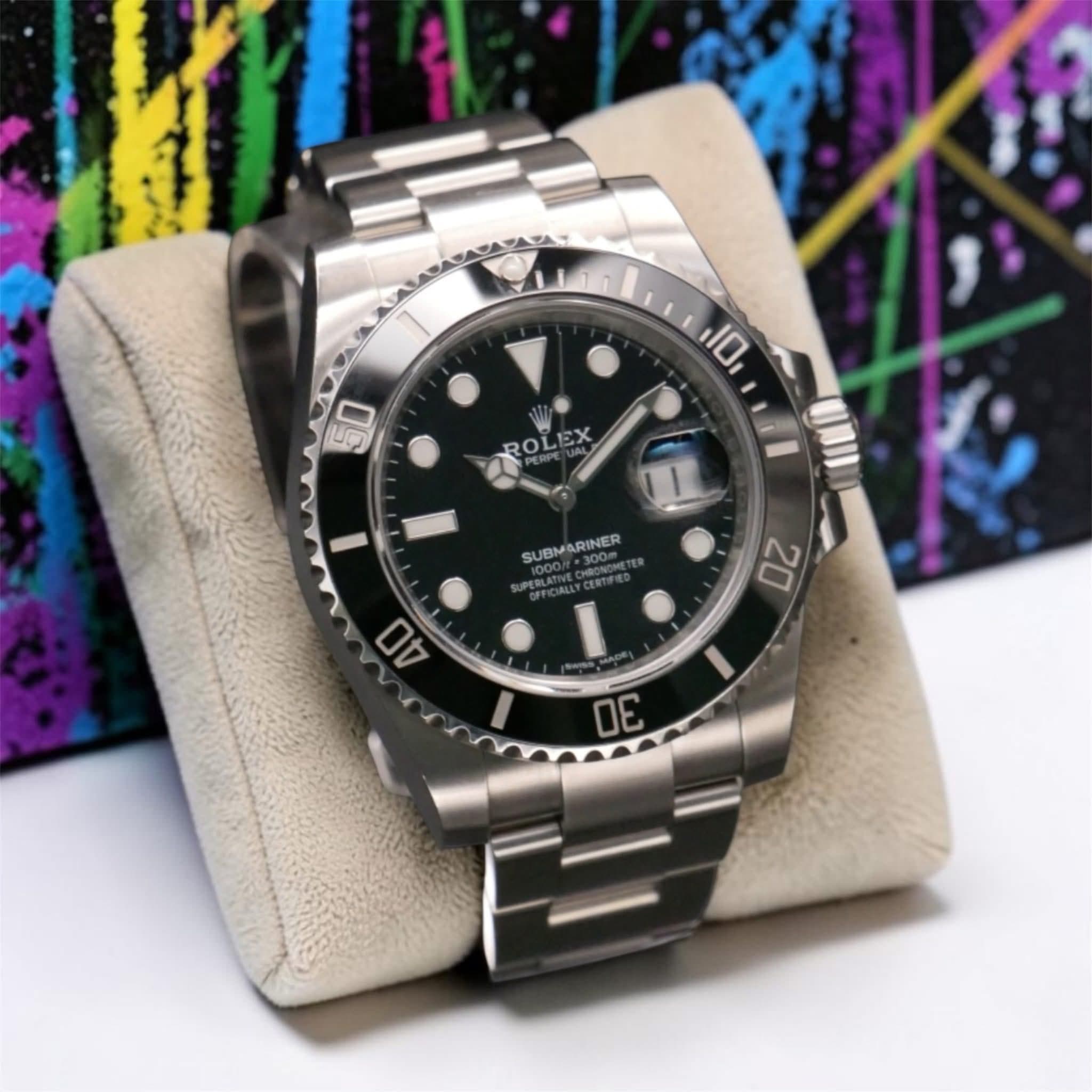 May be an image of wrist watch and text that says 'វំ 10 50 ROLEX EX ROL 1 SUBMARINER UPERLATTVE 40 20 I 30'