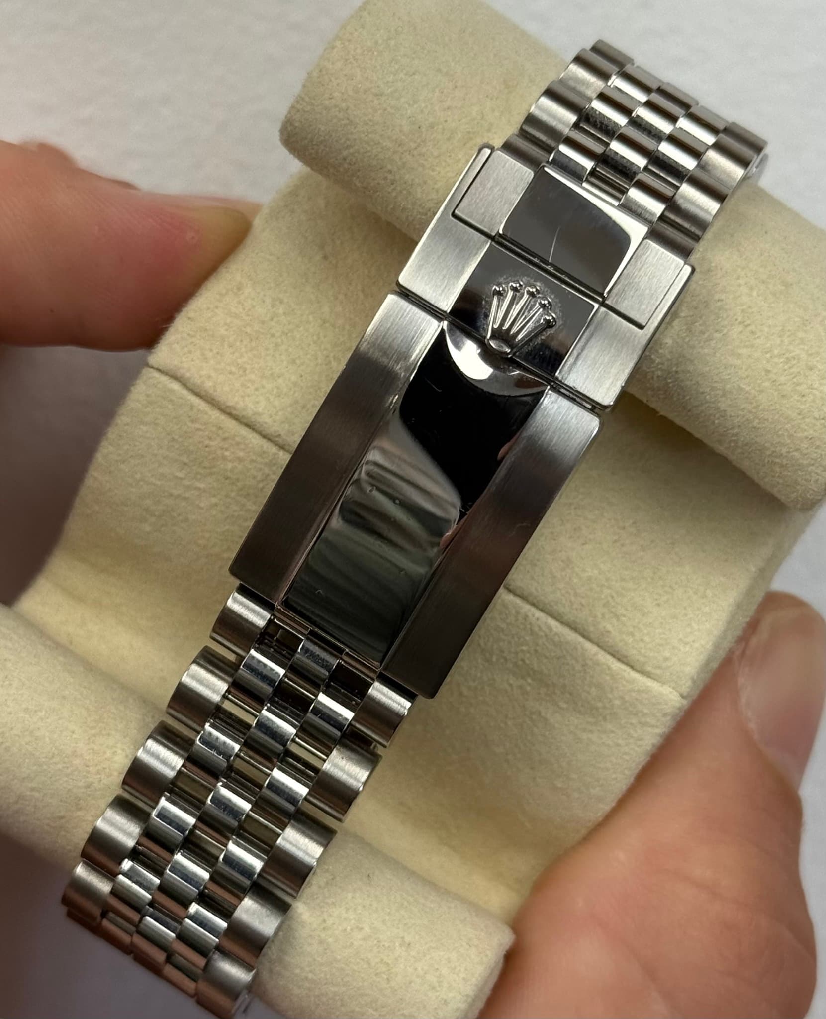 May be an image of jewelry, wrist watch and text