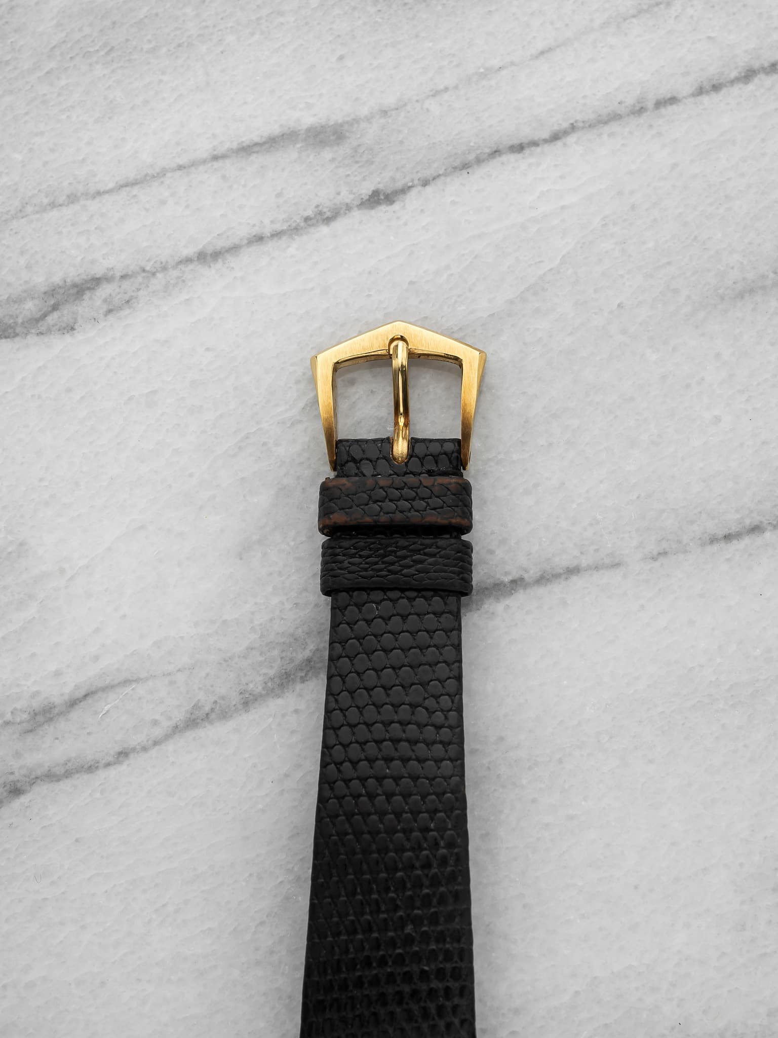 May be an image of leather, saddle-stitched leather and wrist watch