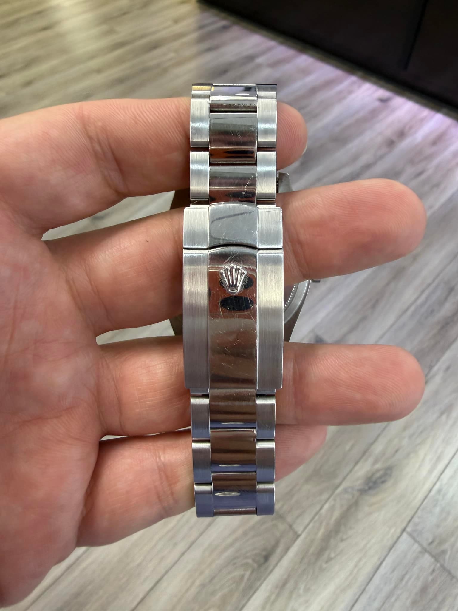 May be an image of wrist watch and text