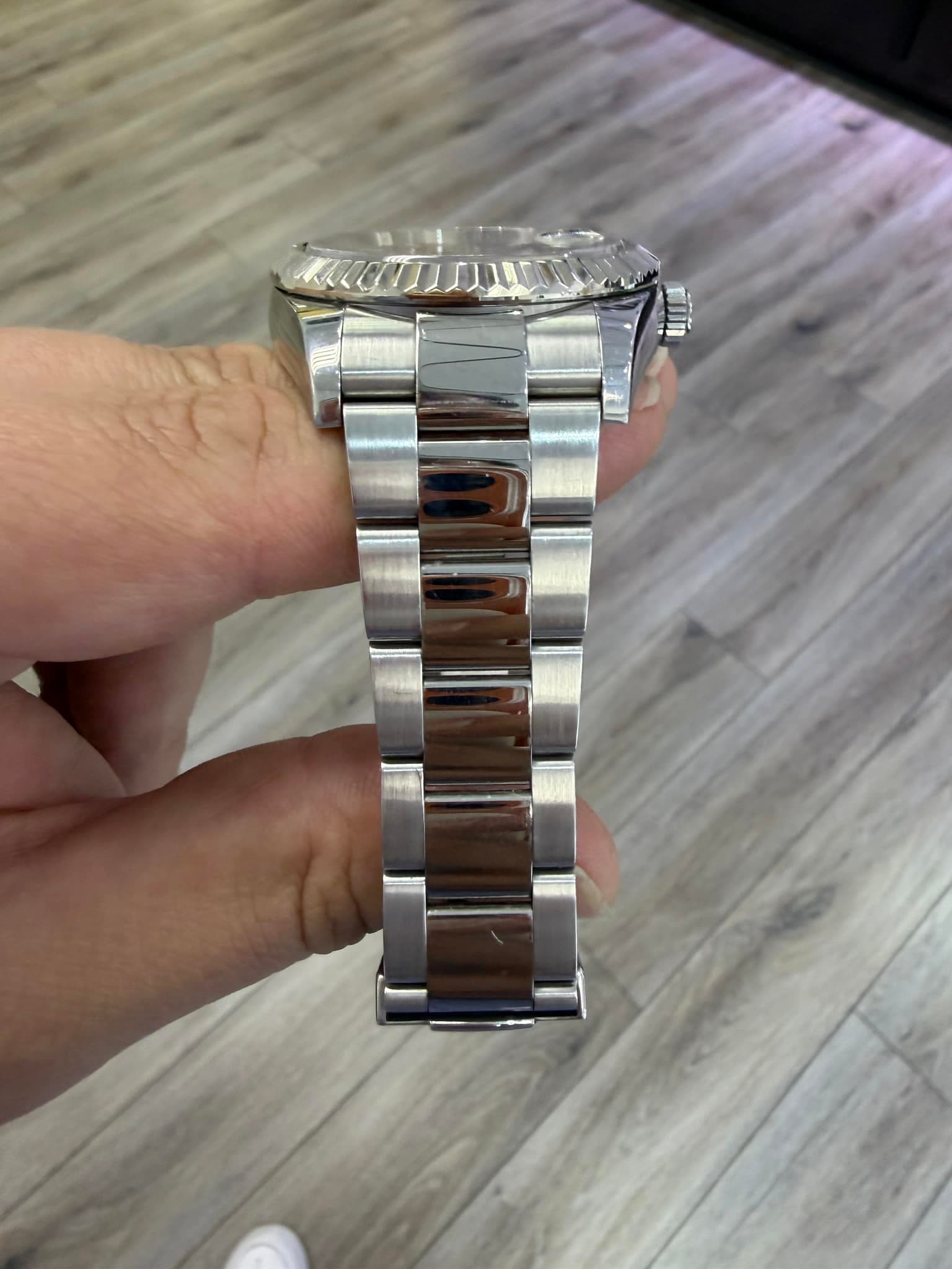 May be an image of wrist watch and text