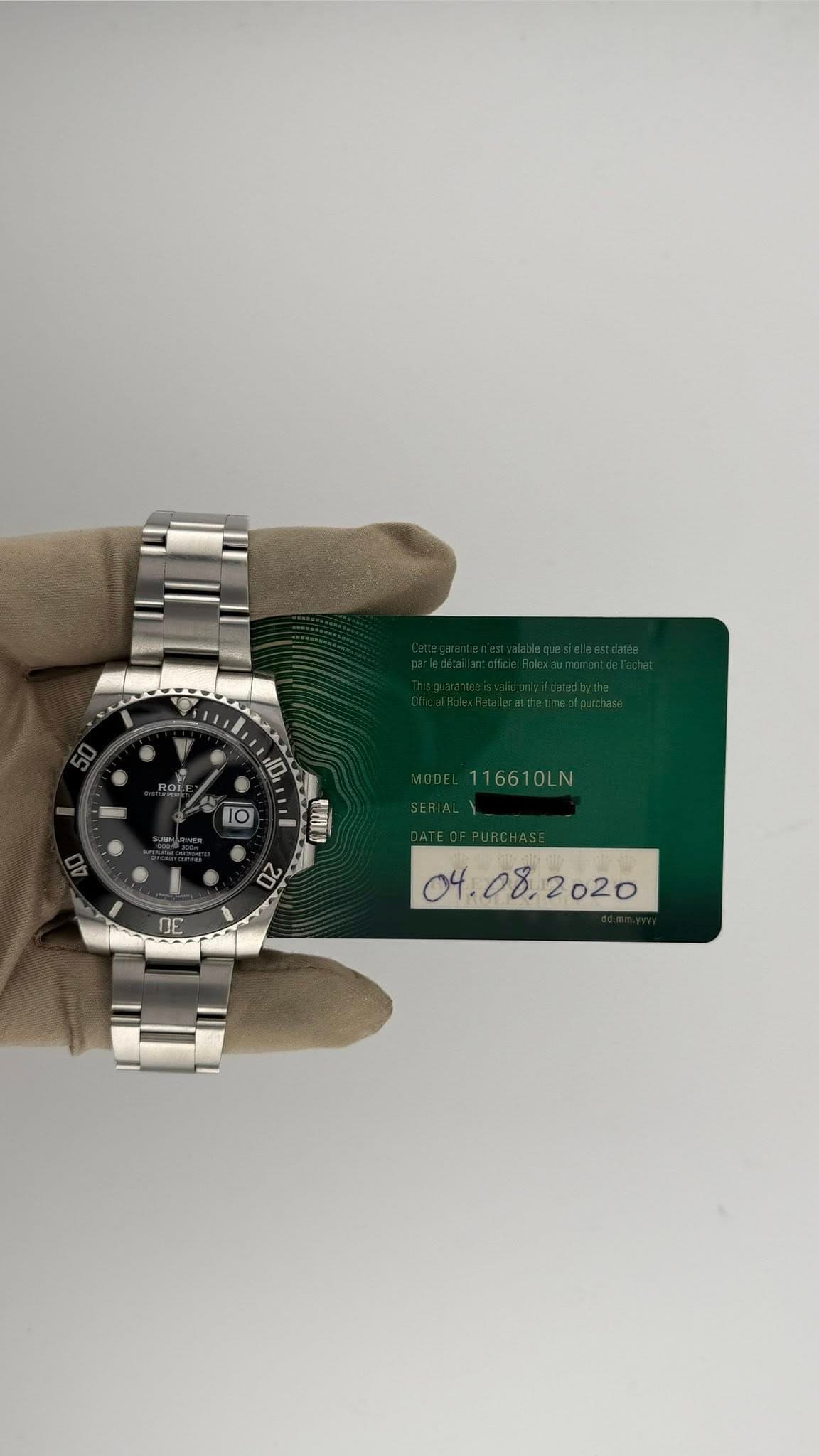 May be an image of wrist watch and text that says 'H0 10 I 16610LN 20 BE 04.08, '
