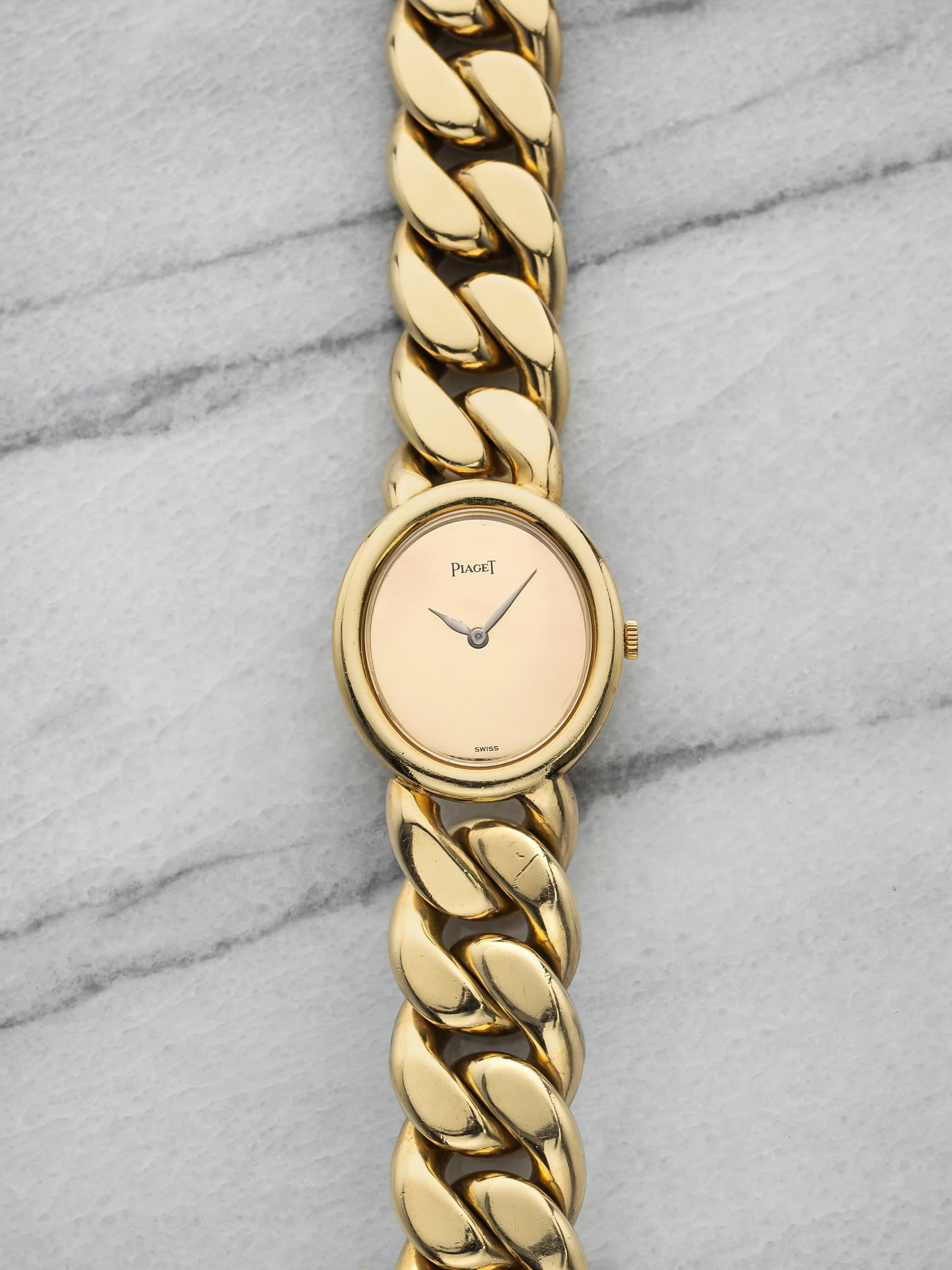 May be an image of jewelry, wrist watch and text