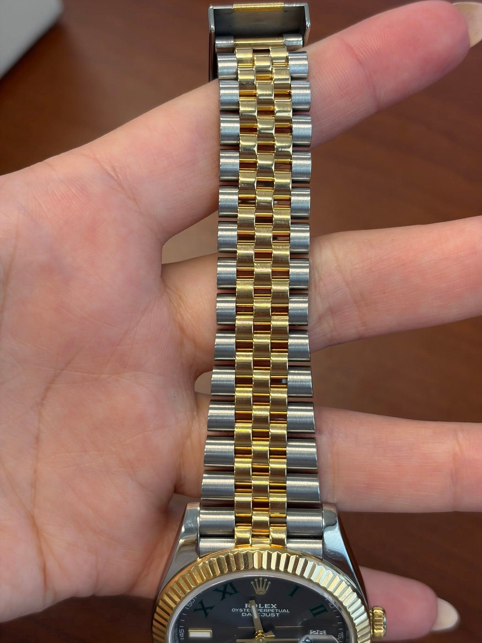 May be an image of wrist watch and text