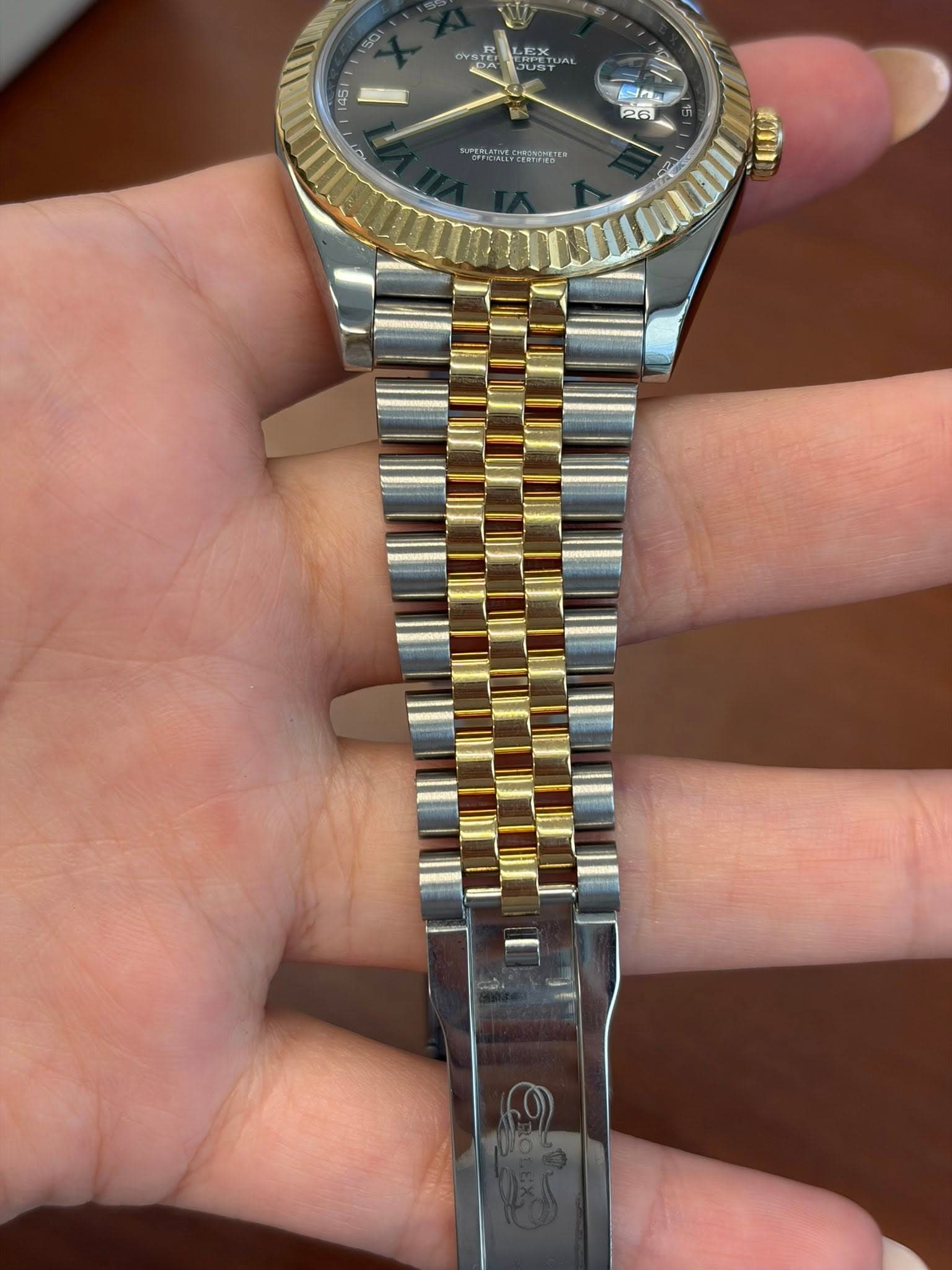 May be an image of wrist watch and text