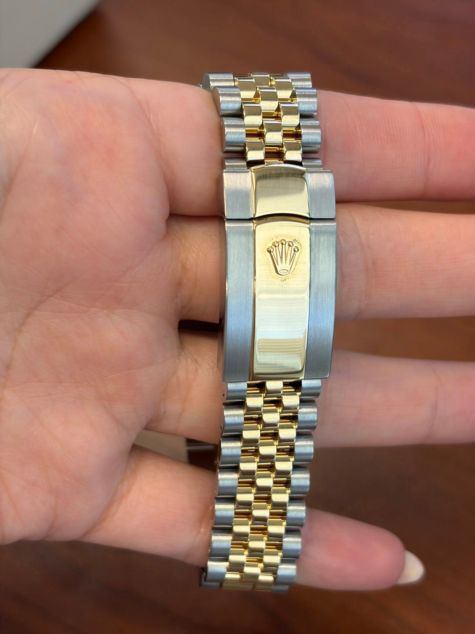 May be an image of wrist watch and text