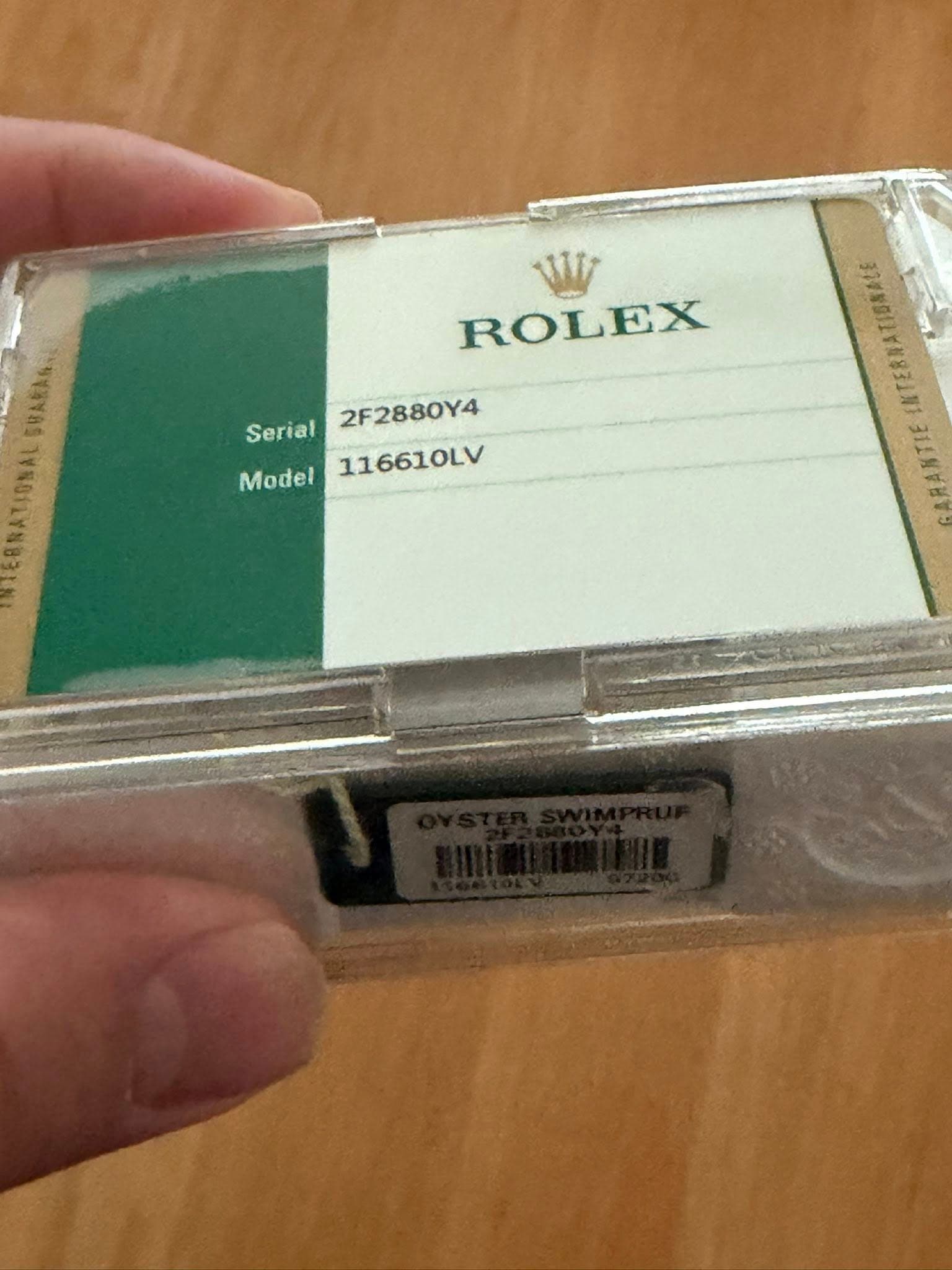 May be an image of wrist watch and text that says 'Serial ROLEX 2F2880Y4 Model 116610LV 三'