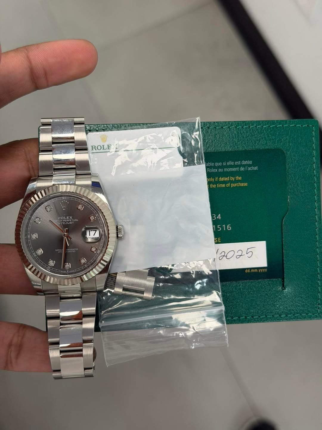 May be an image of wrist watch and text