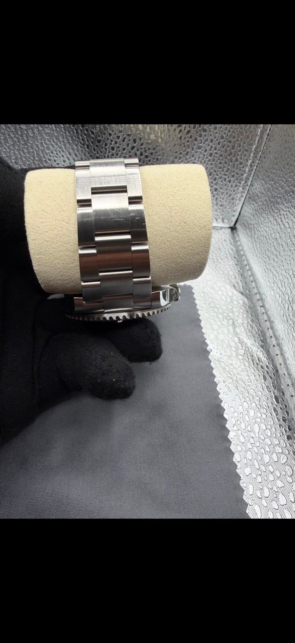 May be an image of leather, wrist watch and text
