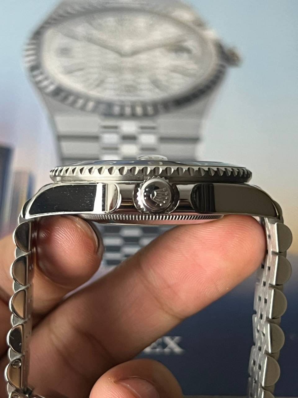 May be an image of wrist watch and text