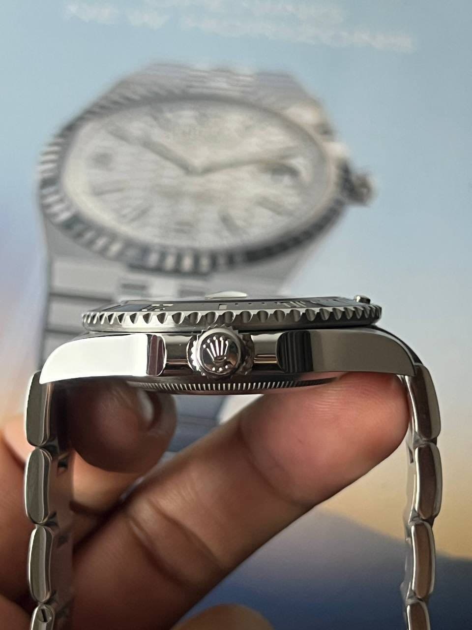 May be an image of wrist watch and text