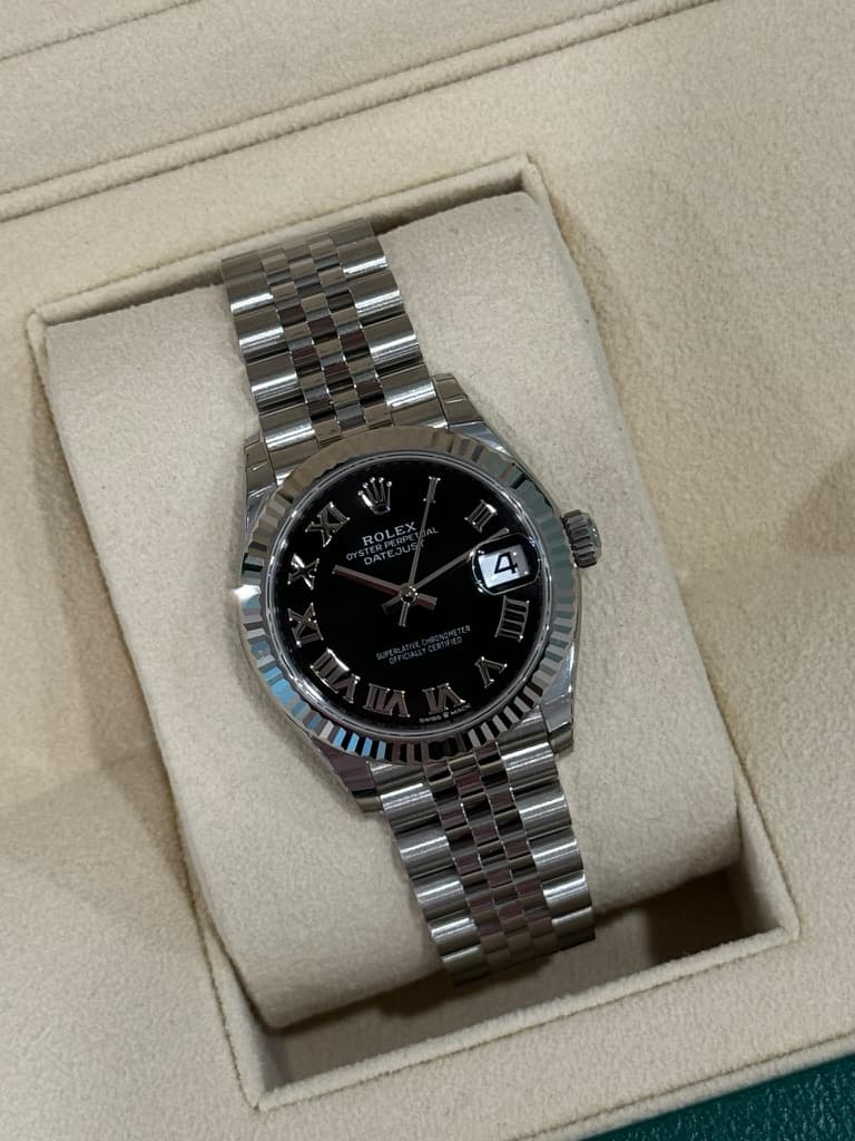 May be an image of wrist watch and text