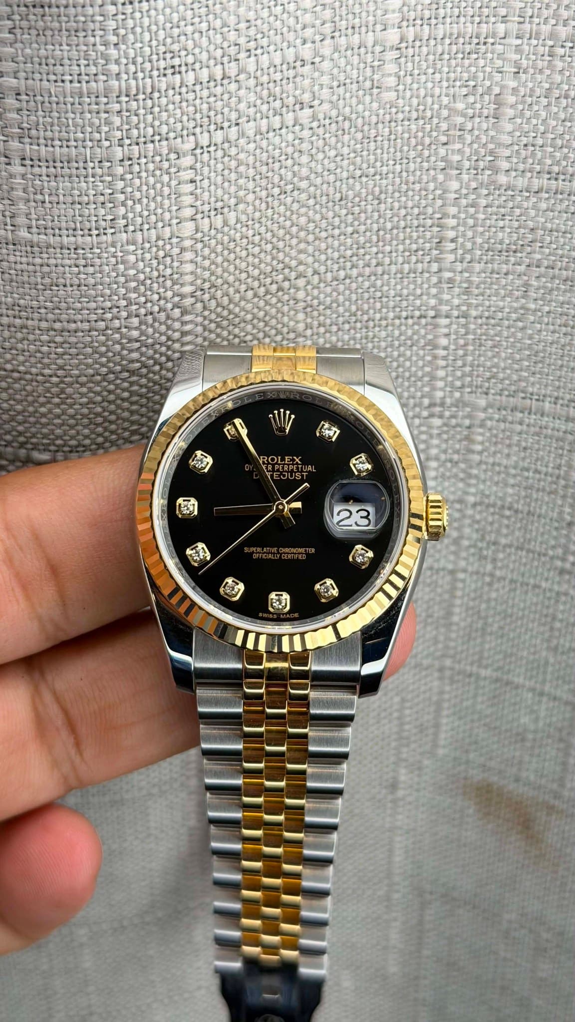 May be an image of wrist watch and text