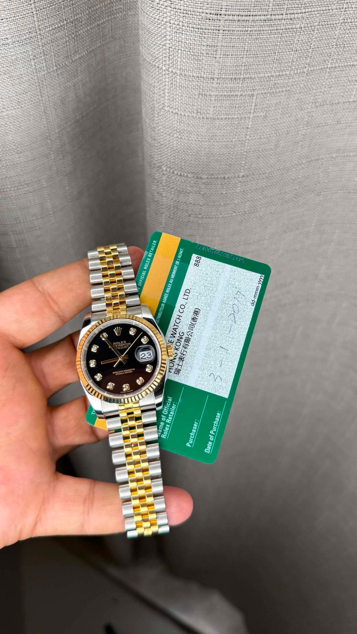 May be an image of money, wrist watch and text
