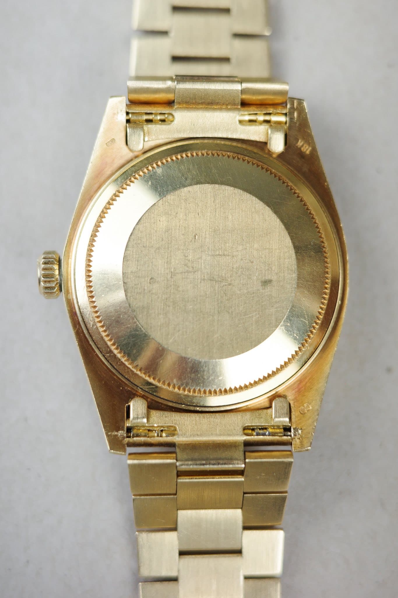 May be an image of wrist watch and text