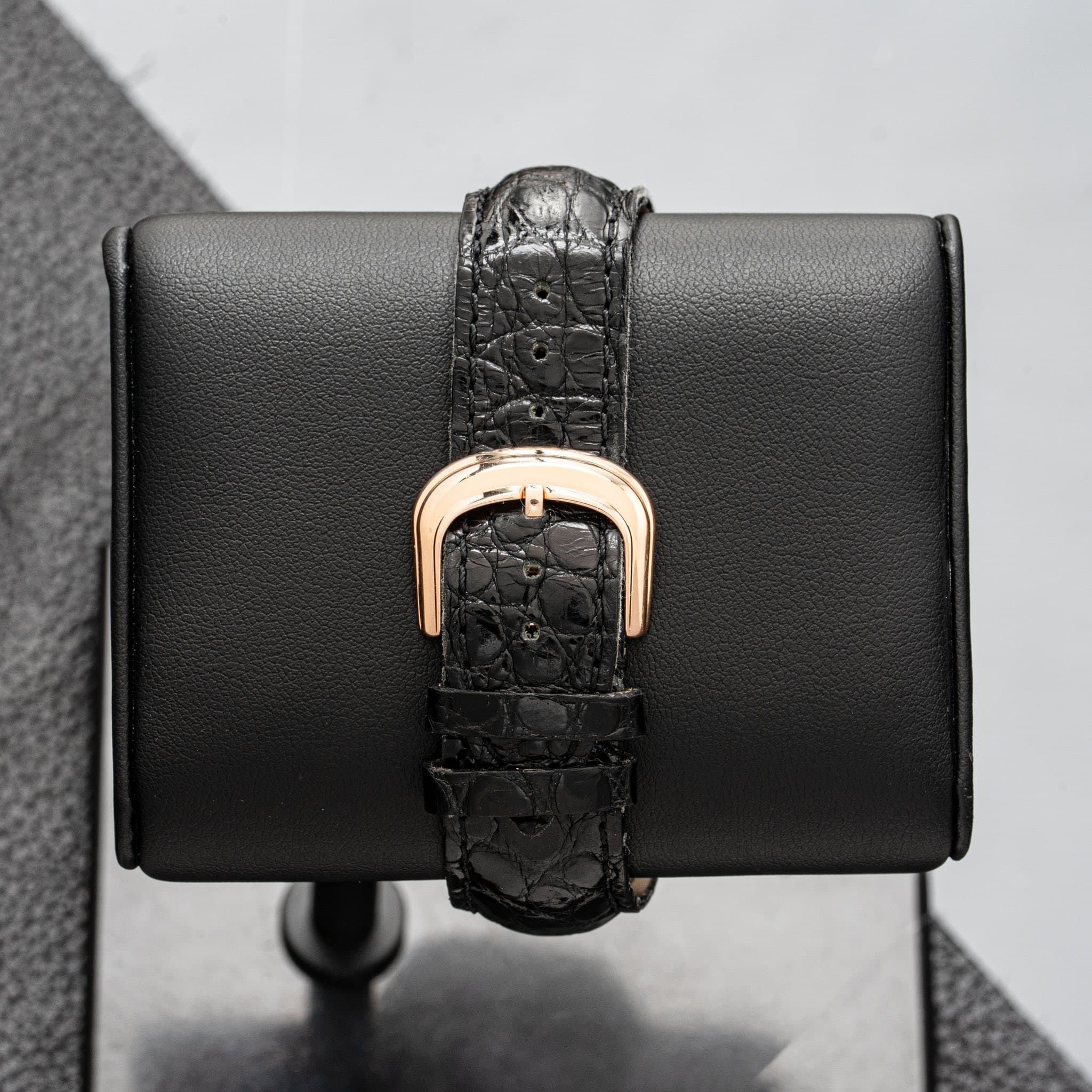 May be an image of leather wallet, leather, wrist watch and saddle-stitched leather