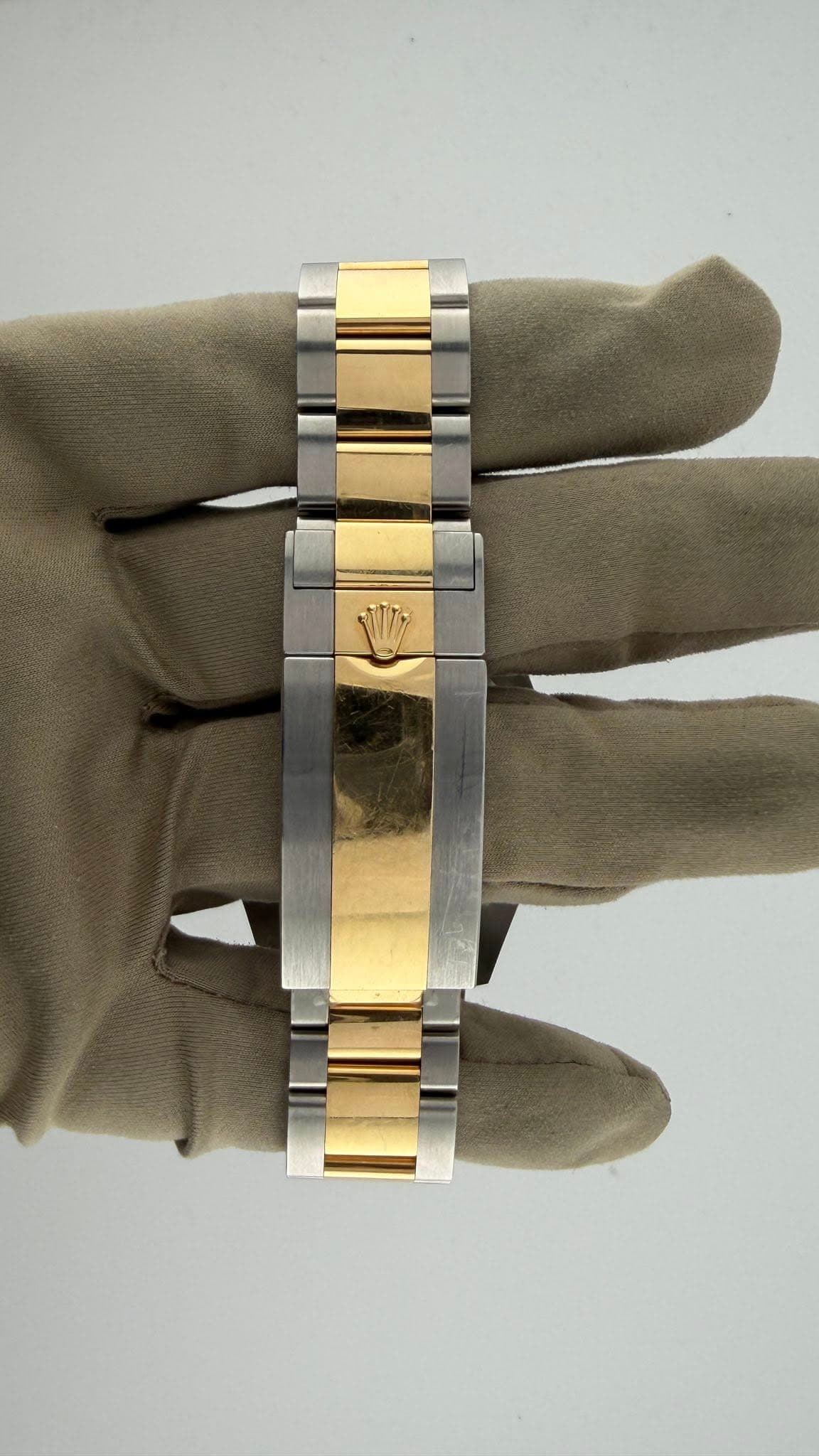 May be an image of brass, wrist watch and jewelry