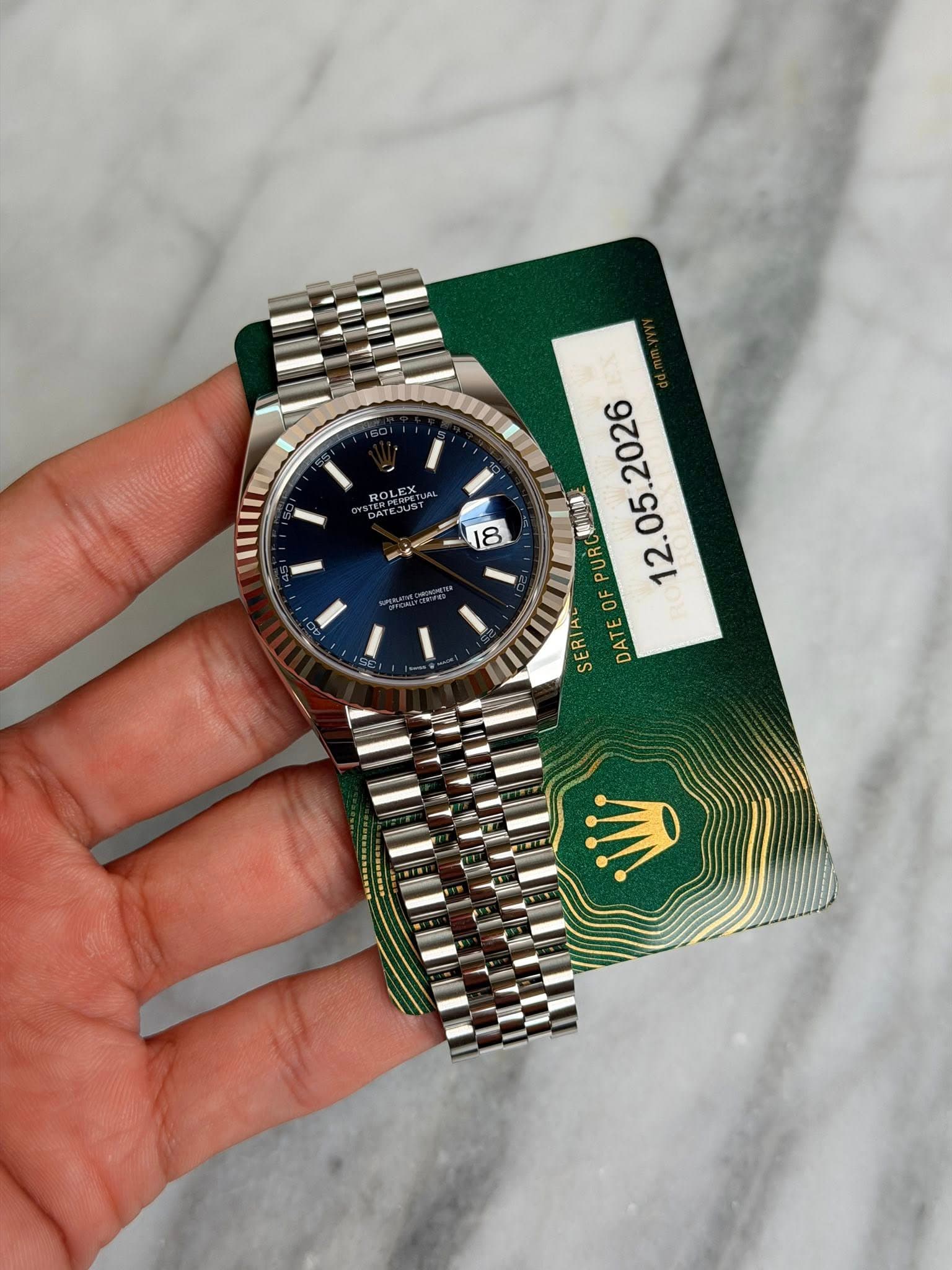 May be an image of wrist watch and text that says 'ROLEX キコUSす 18 糖1018 05. PUR F 12. F OF SERIAL SER DATE'