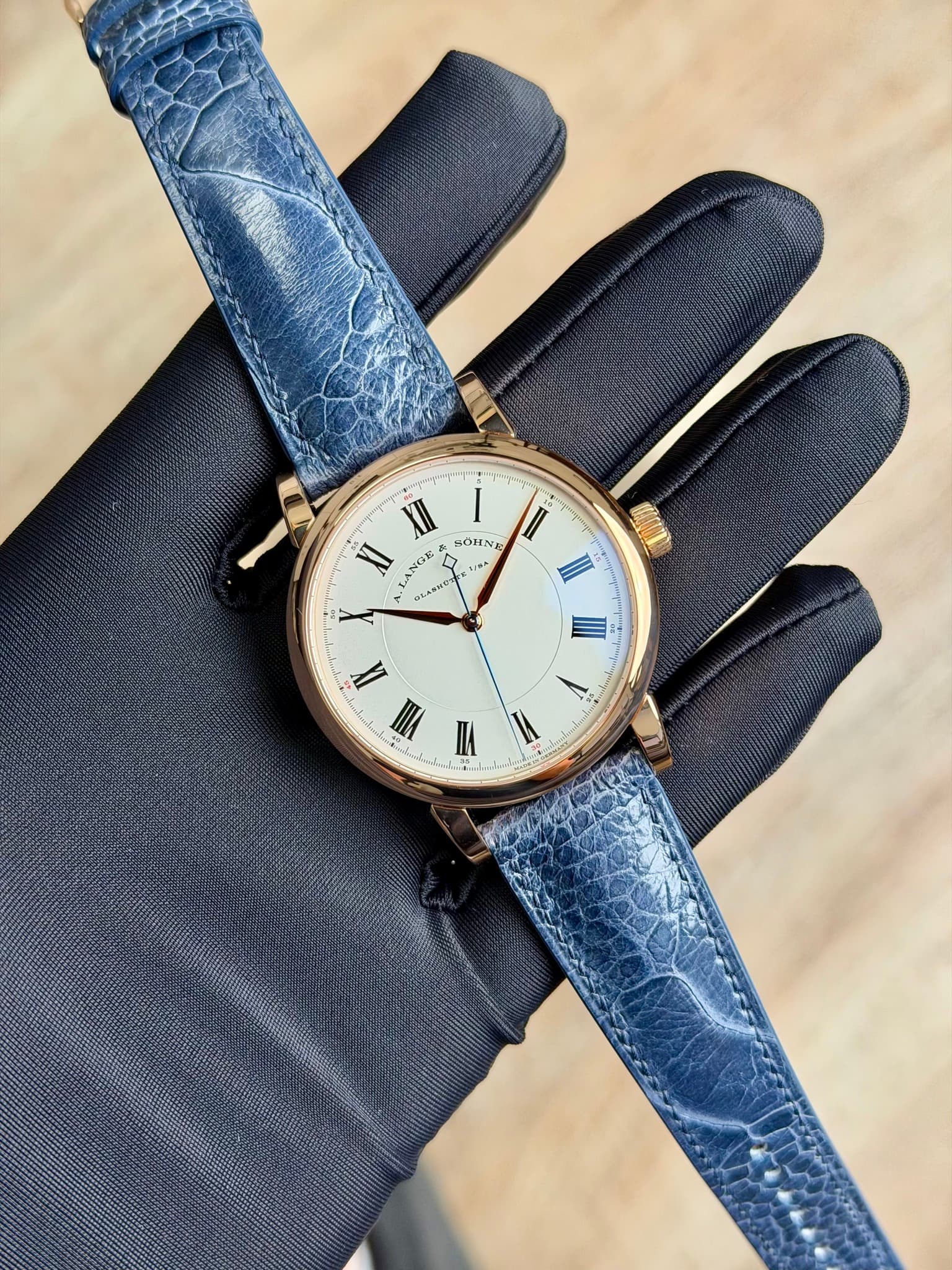 May be an image of leather, wrist watch and text