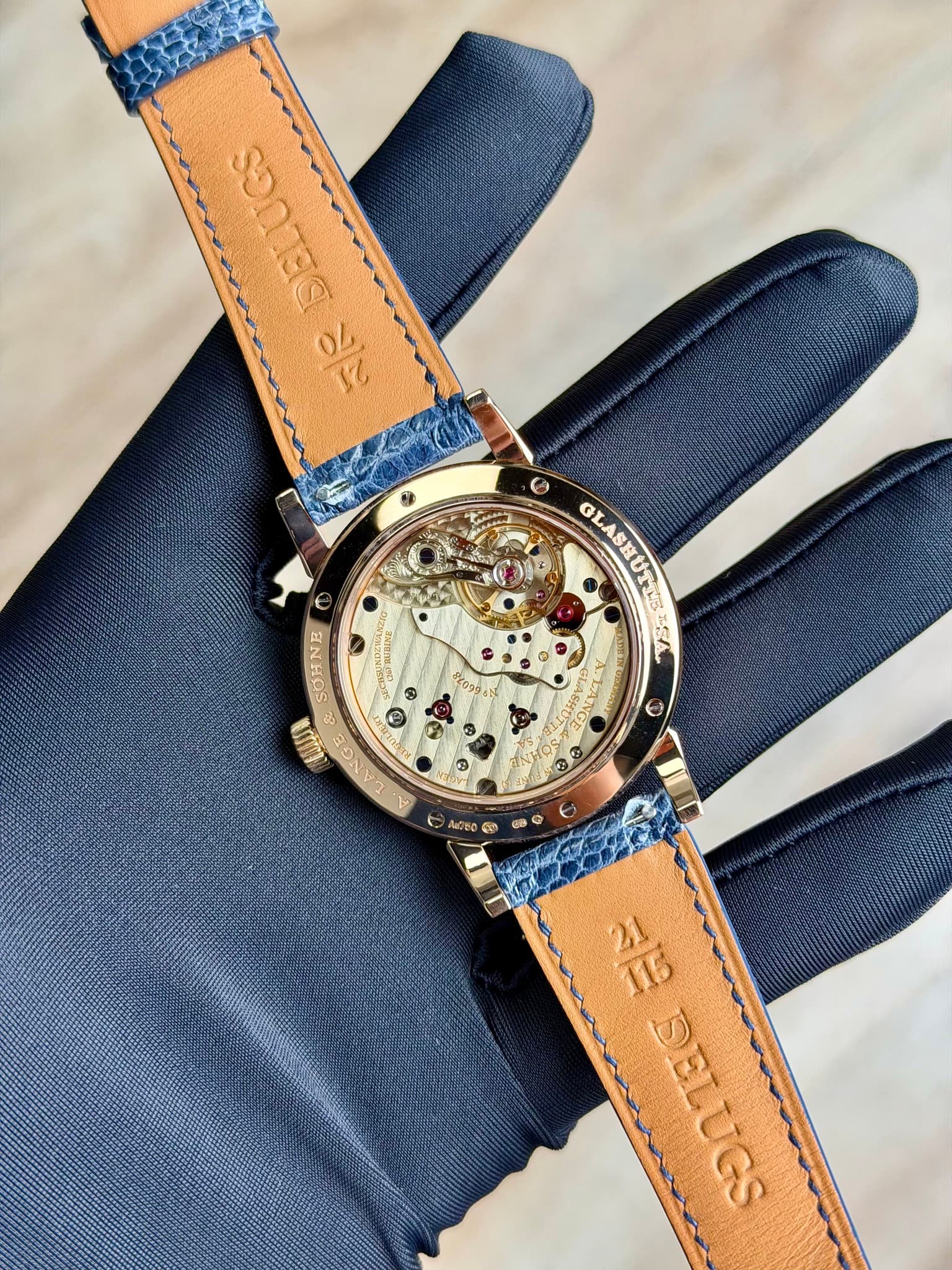 May be an image of leather, wrist watch and text