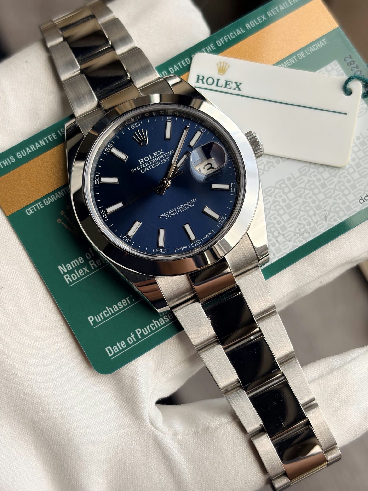 May be an image of wrist watch and text that says 'RETAILE ROLEX OFFICIAL THE UDATED DDATED ROLEX MENT DE L'ACHAT 22202 GUARANTEE HIS 55 60 ای ROLEX TERPERPETU PERPET 22 OY…