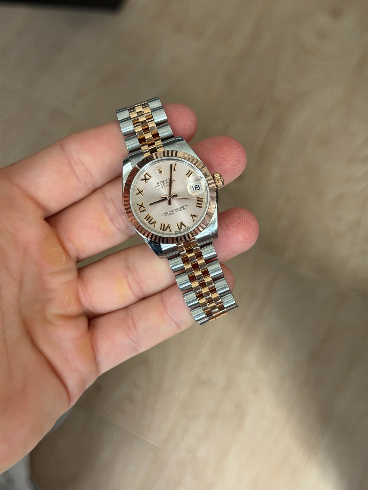 May be an image of wrist watch and text