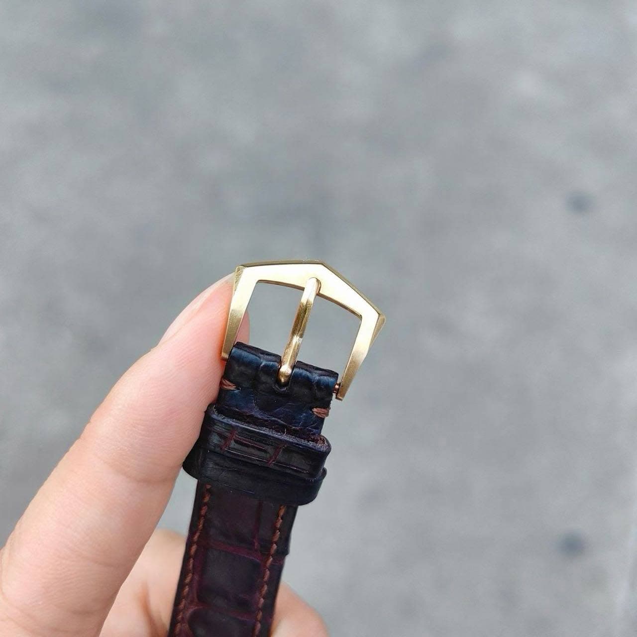 May be an image of wrist watch and saddle-stitched leather