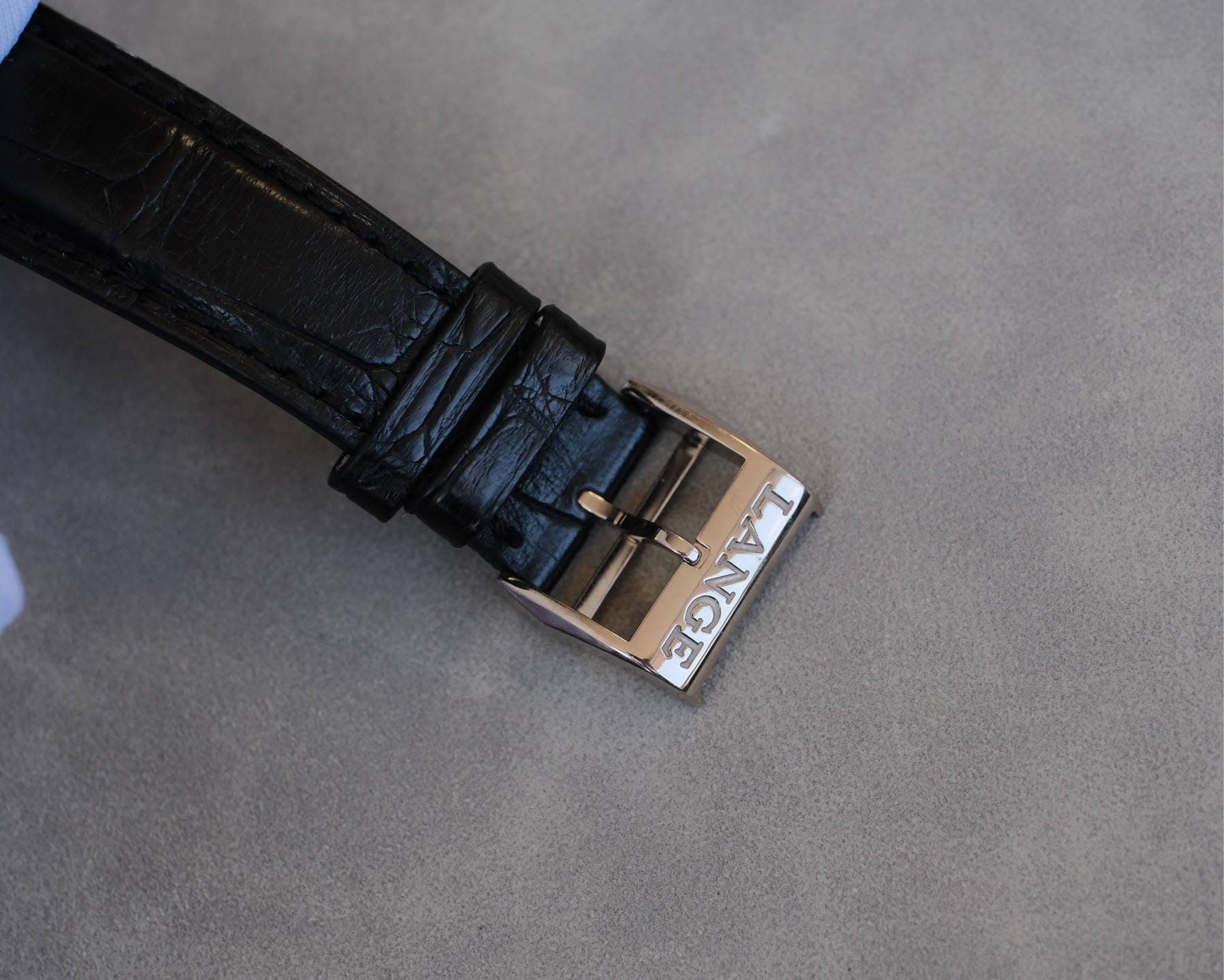 May be an image of saddle-stitched leather, wrist watch and leather