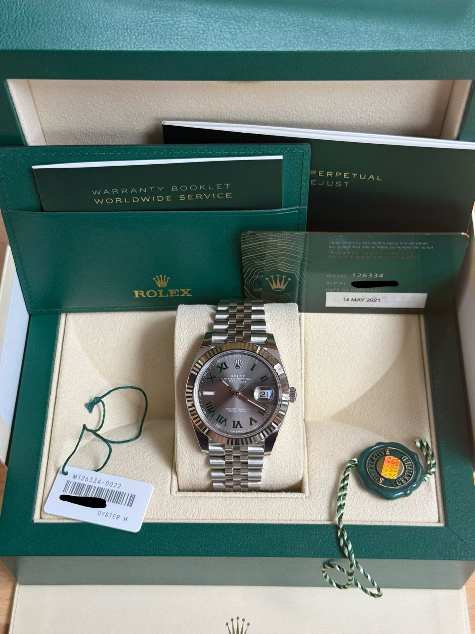 May be an image of wrist watch and text that says 'WARRANTYBOOKLET WARRANTY WORLDWIDESERVICF WORLDWIDE ERVICE ERPETUAL MAY 14MAY2021 2021 عن Car - 21 سا M126334 OYSTER M'