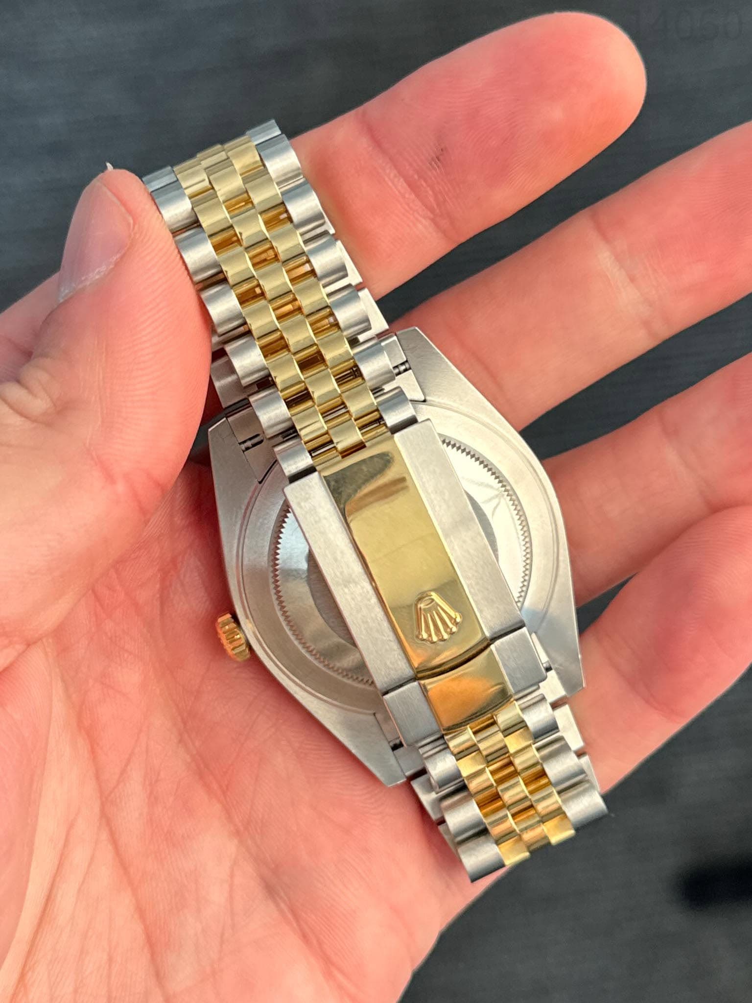 May be an image of wrist watch and text