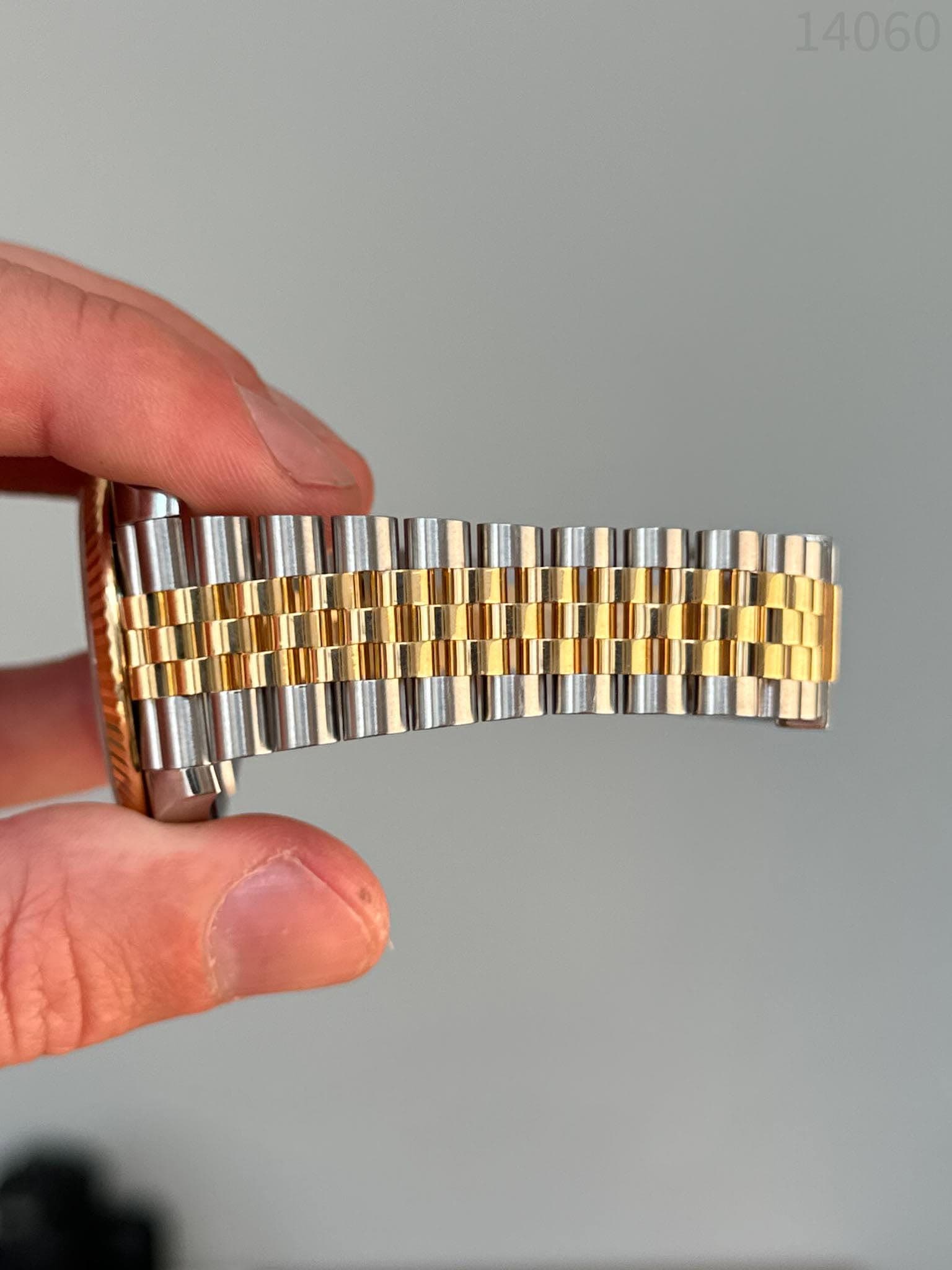 May be an image of wrist watch and text