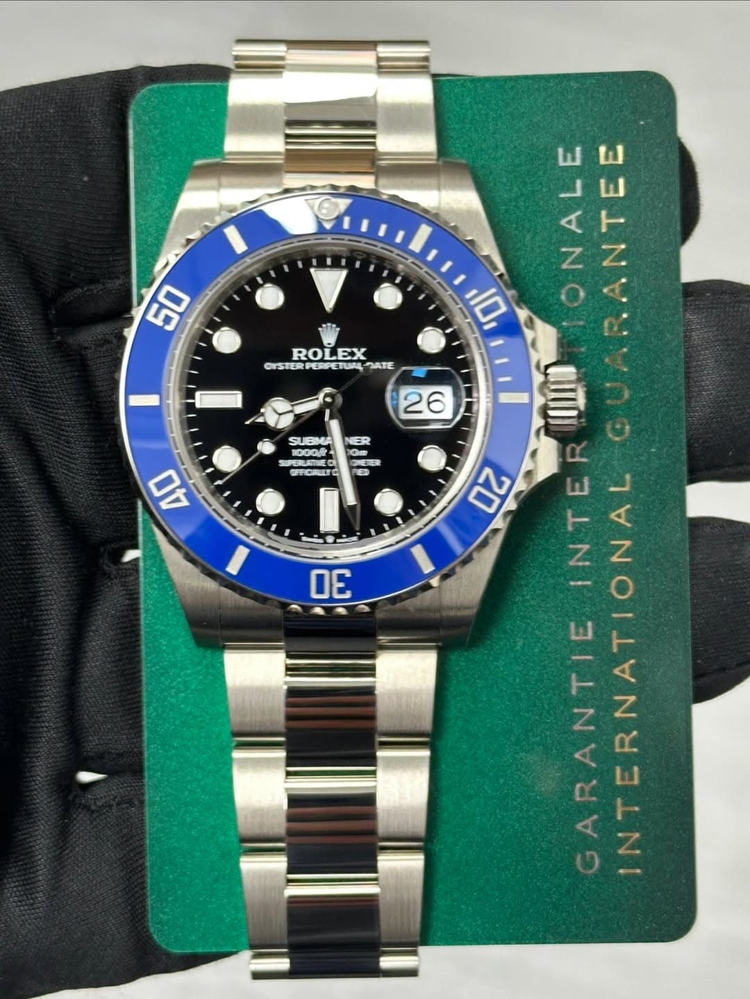 May be an image of wrist watch and text that says '50 ROLEX OISTER JATE ٧ ONALE 10 JIトNA 26 ER SUBIMA 1000 1000f PERURTNE おC間 電者 40 30 20 INTER E ARANTIE INTERNATIONAL'