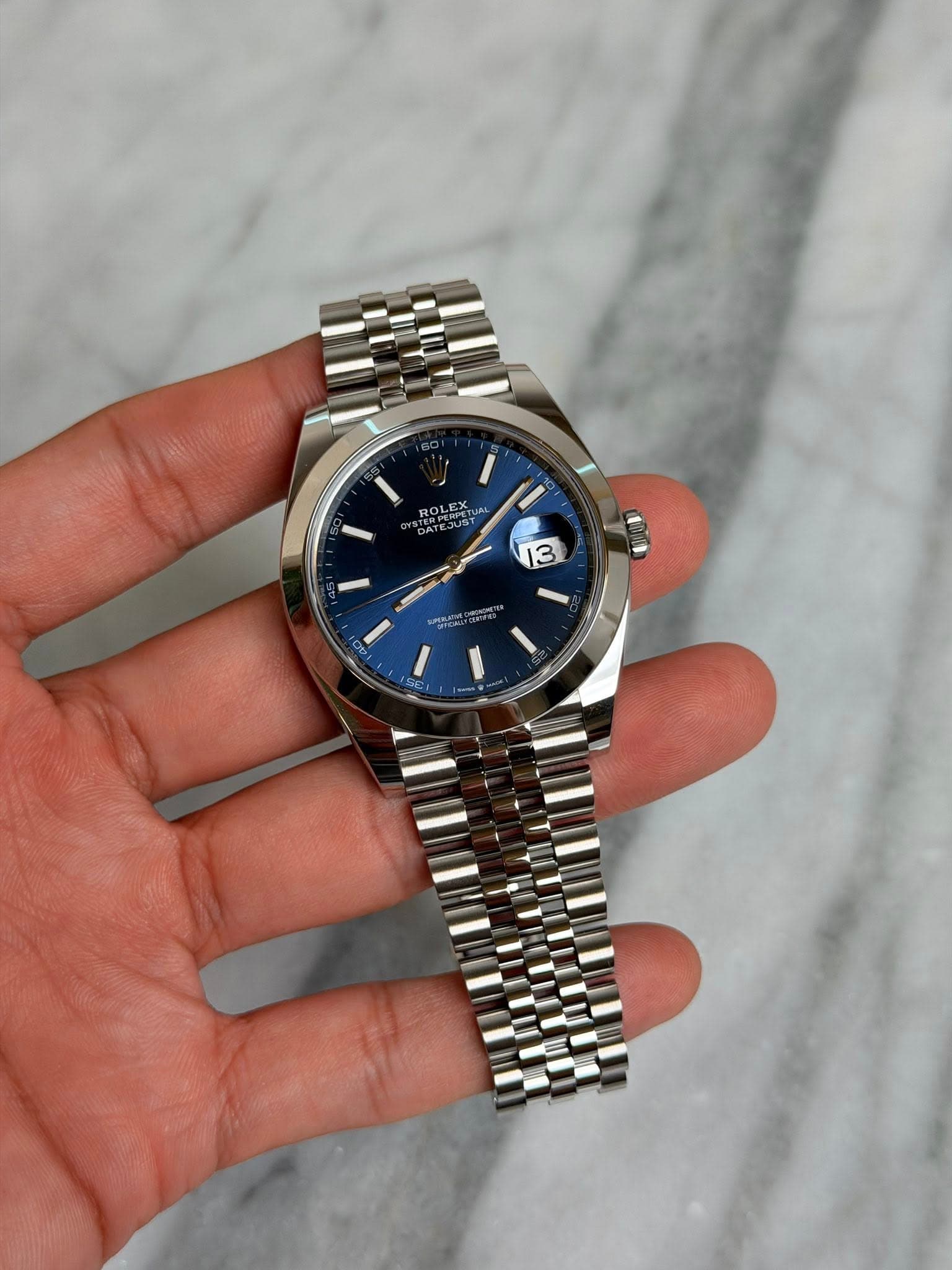 May be an image of wrist watch and text that says 'ROLEXTU ERUS TEJUST t 31 JUS 13'