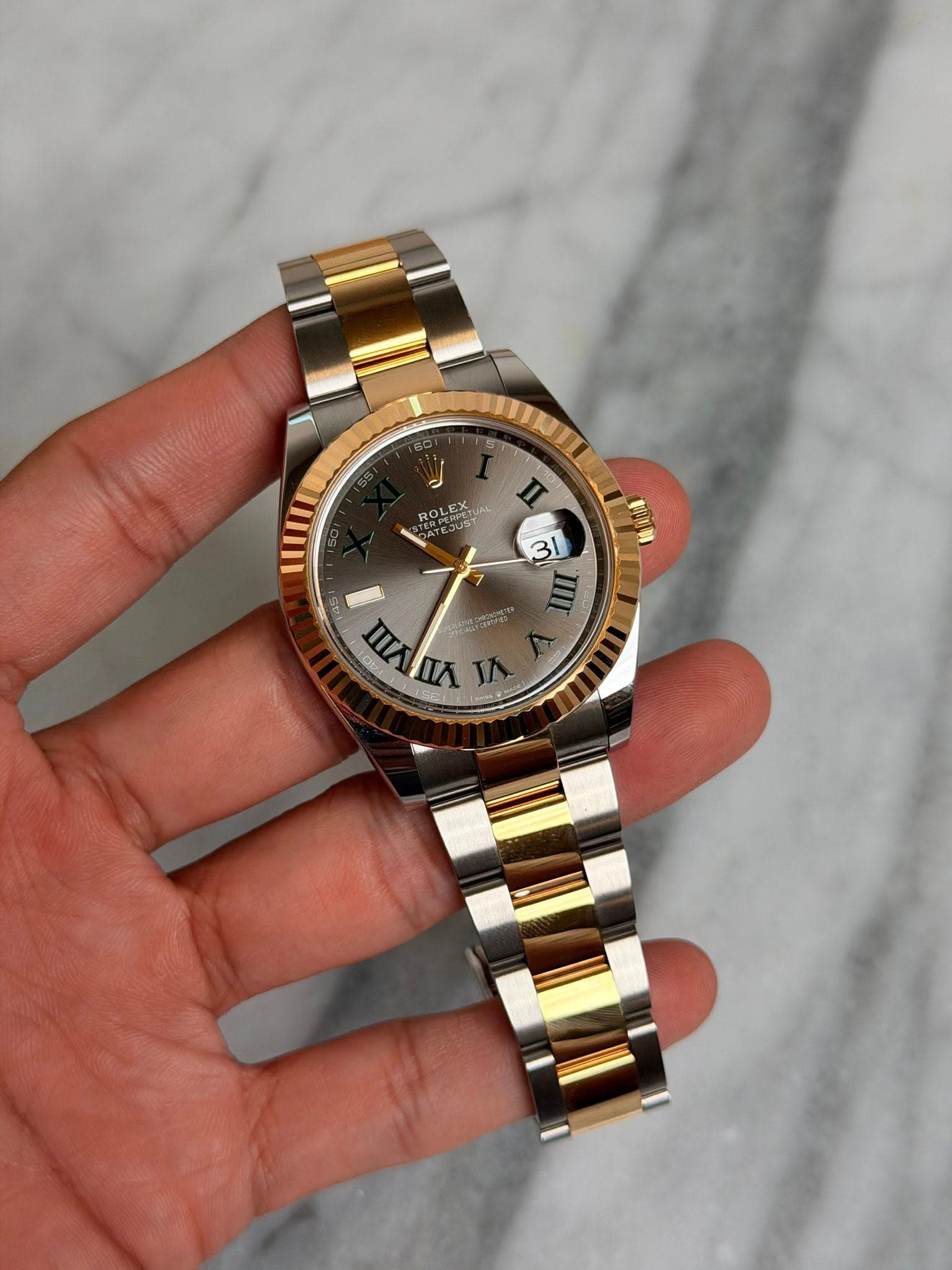 May be an image of wrist watch and text that says 'ROLEX ROLEA កូ n 31 無 145 4s ) nAn VI 南 VII'