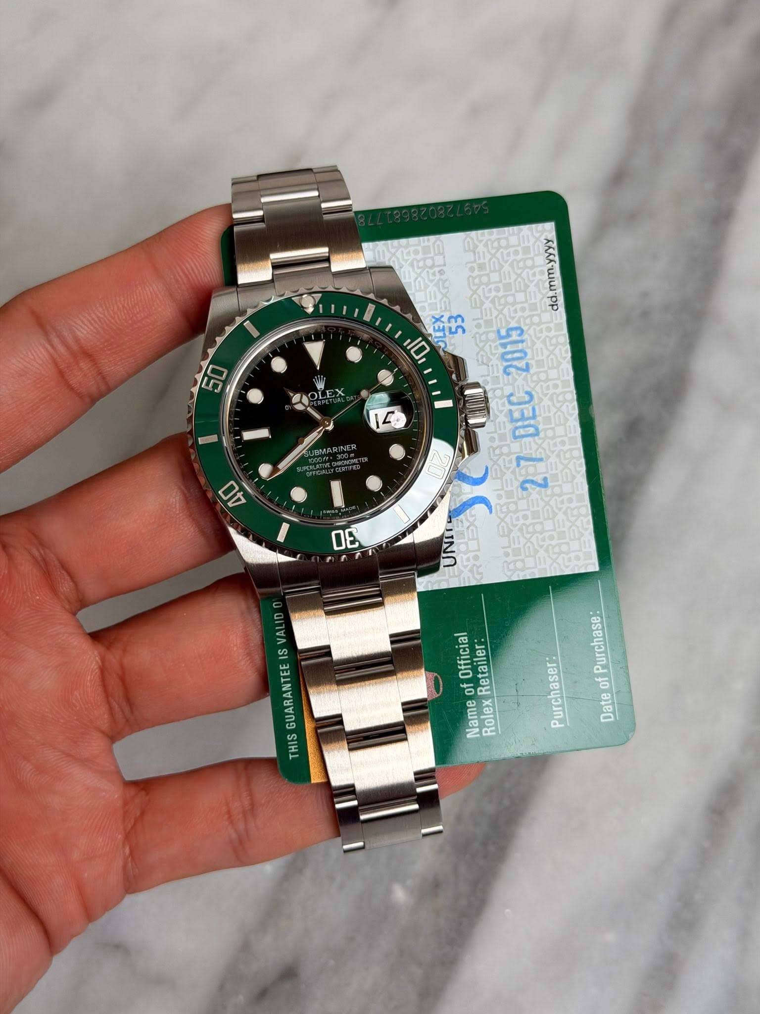 May be an image of wrist watch and text that says '50 14 4 mm.yyyy dd. 10, ឆ្កុហ 2015 5อน 27DEC 27 DEC 3E UNI PUAO VALID Official Retailer: Re GUARANTEE THIS 国 of Name Rolex…