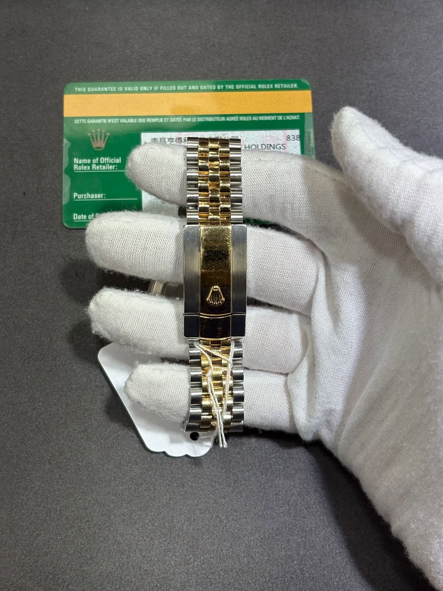 May be an image of jewelry, wrist watch and text