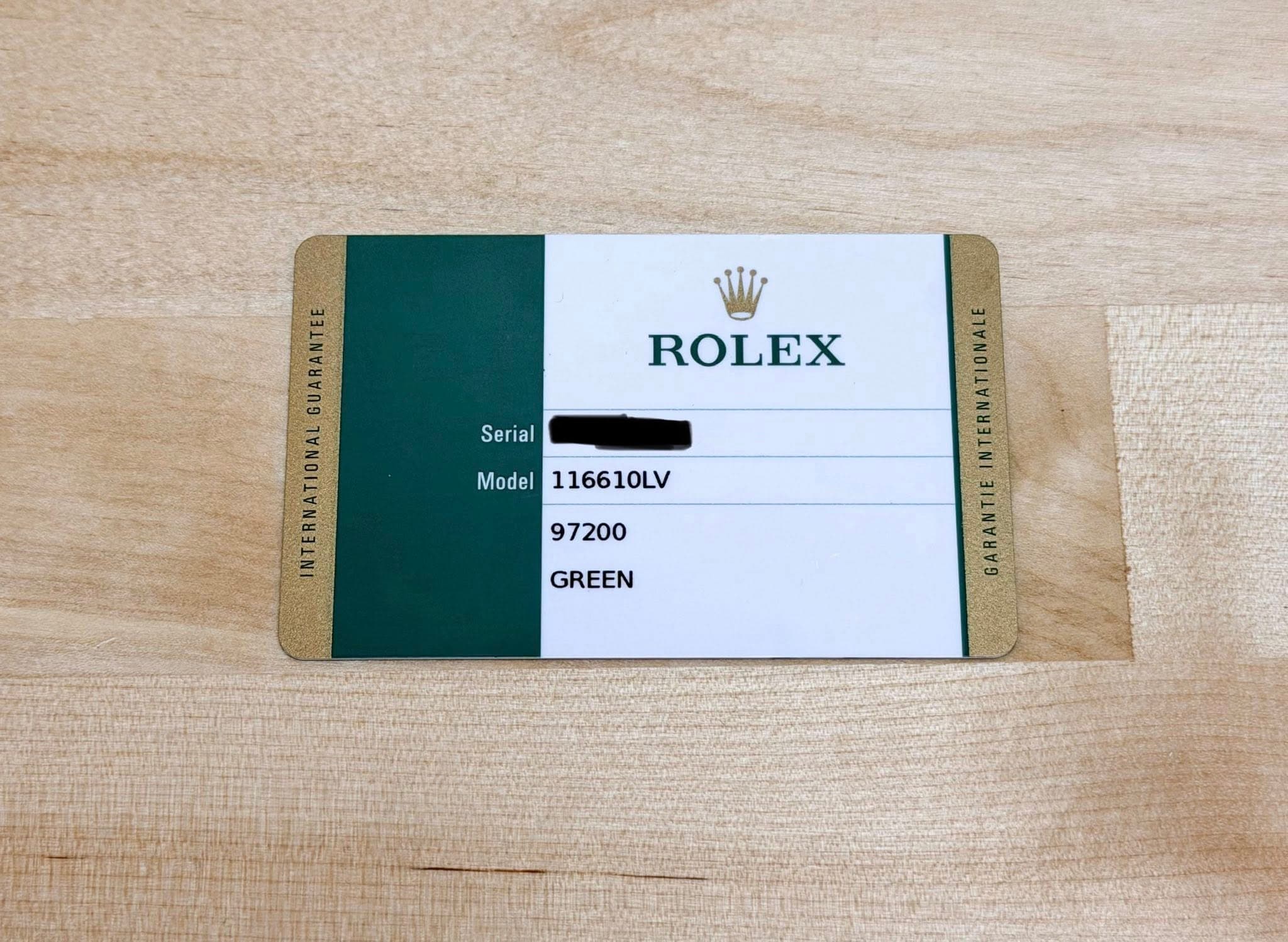 May be an image of wrist watch and text that says 'ROLEX GUARANTEE INTERNATIONAL Serial Model Model116610LV 116610LV 97200 GREEN INTERNATIONALE GARANTIE'