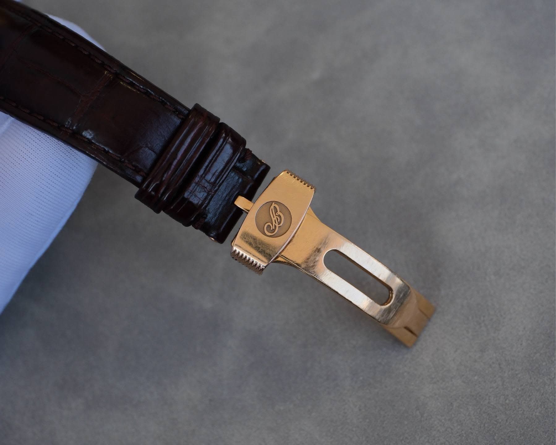 May be an image of wrist watch and saddle-stitched leather