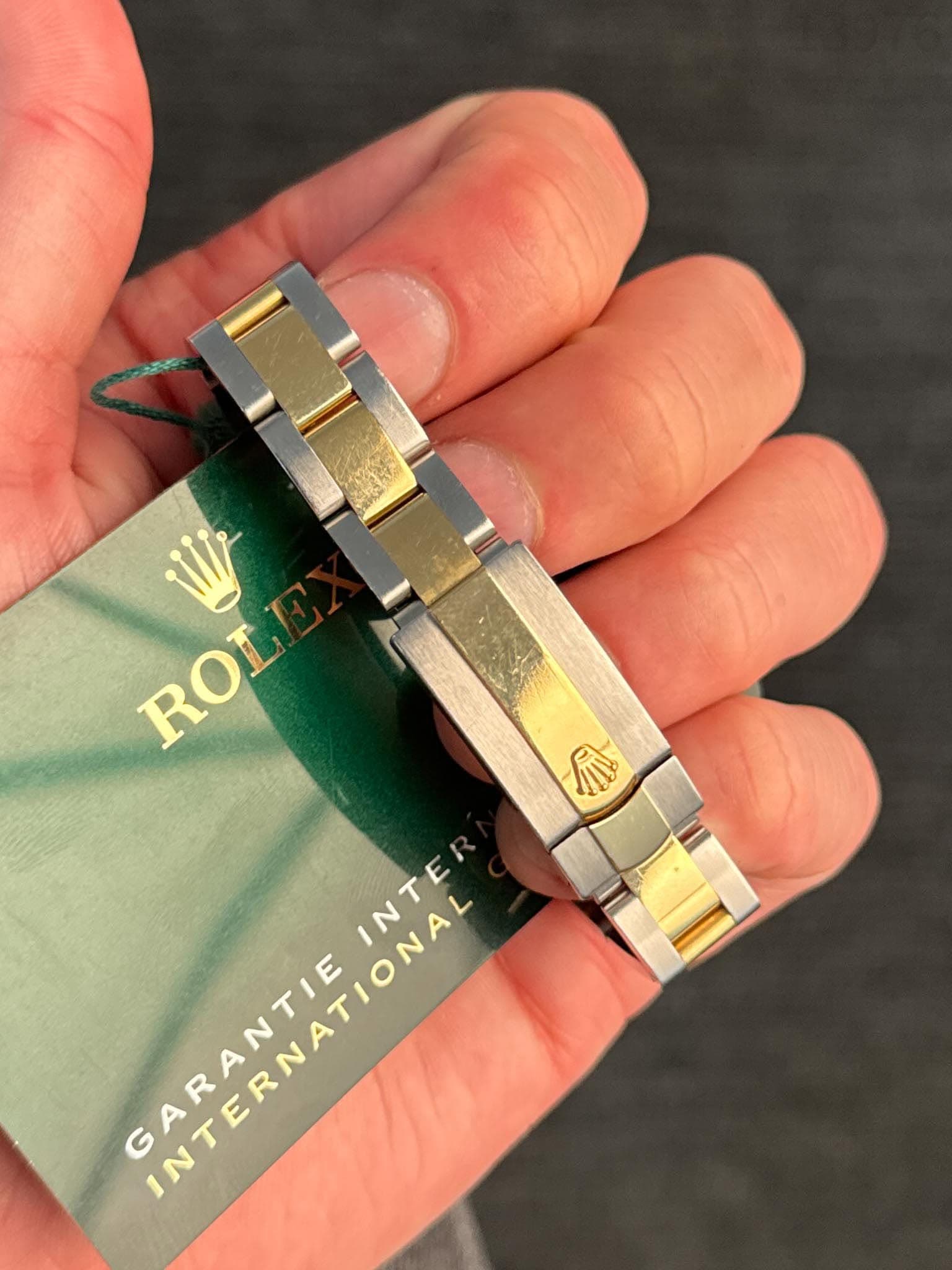 May be an image of wrist watch and text