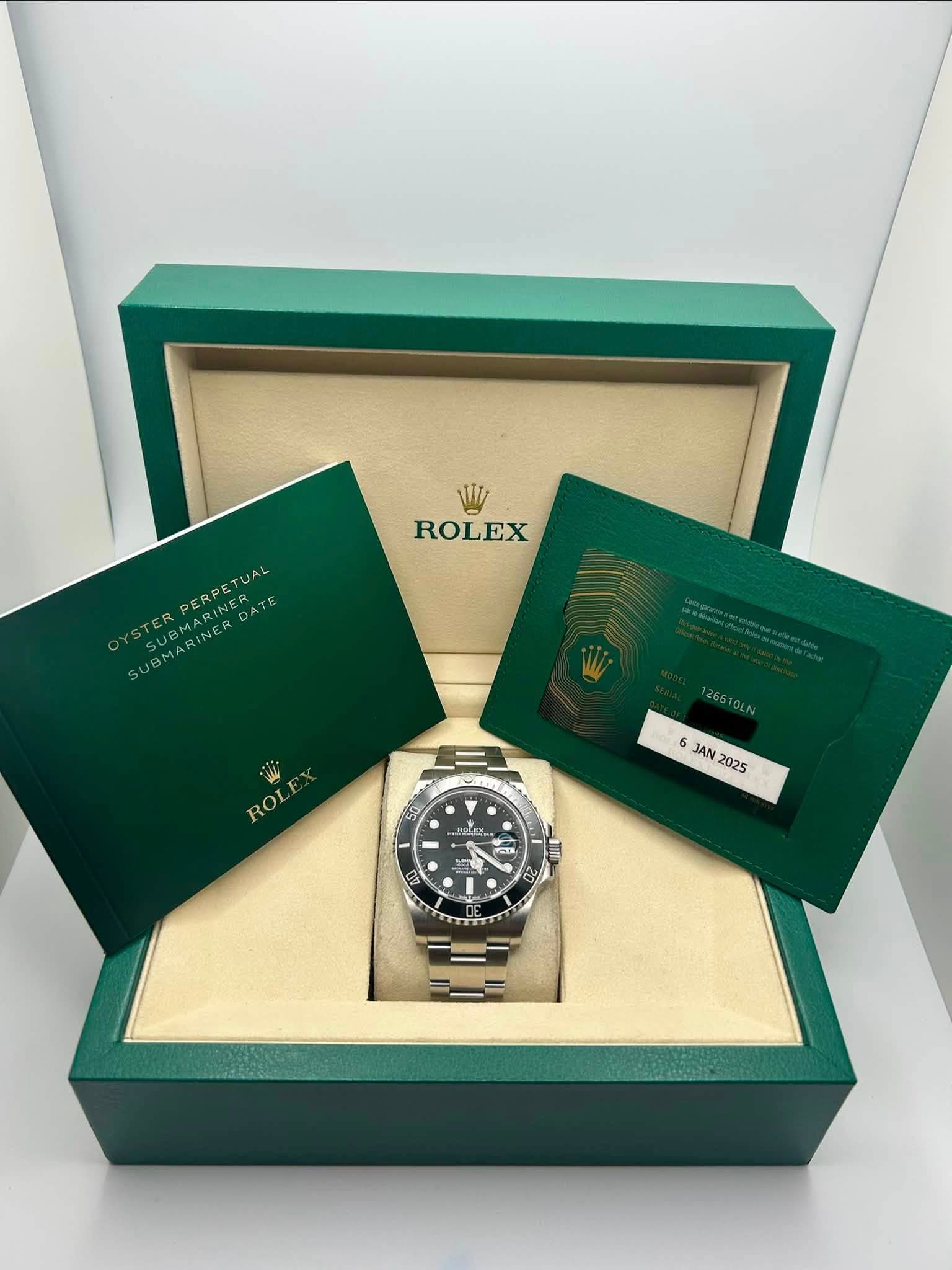 May be an image of wrist watch and text that says 'ROLEX PERPE PERPETUAL TUAL SUBMARIN ER ه DATE 266 26610LN ROL 6 6 JA JAN 2025 mOLES 50 ١ 1 00 - GB'
