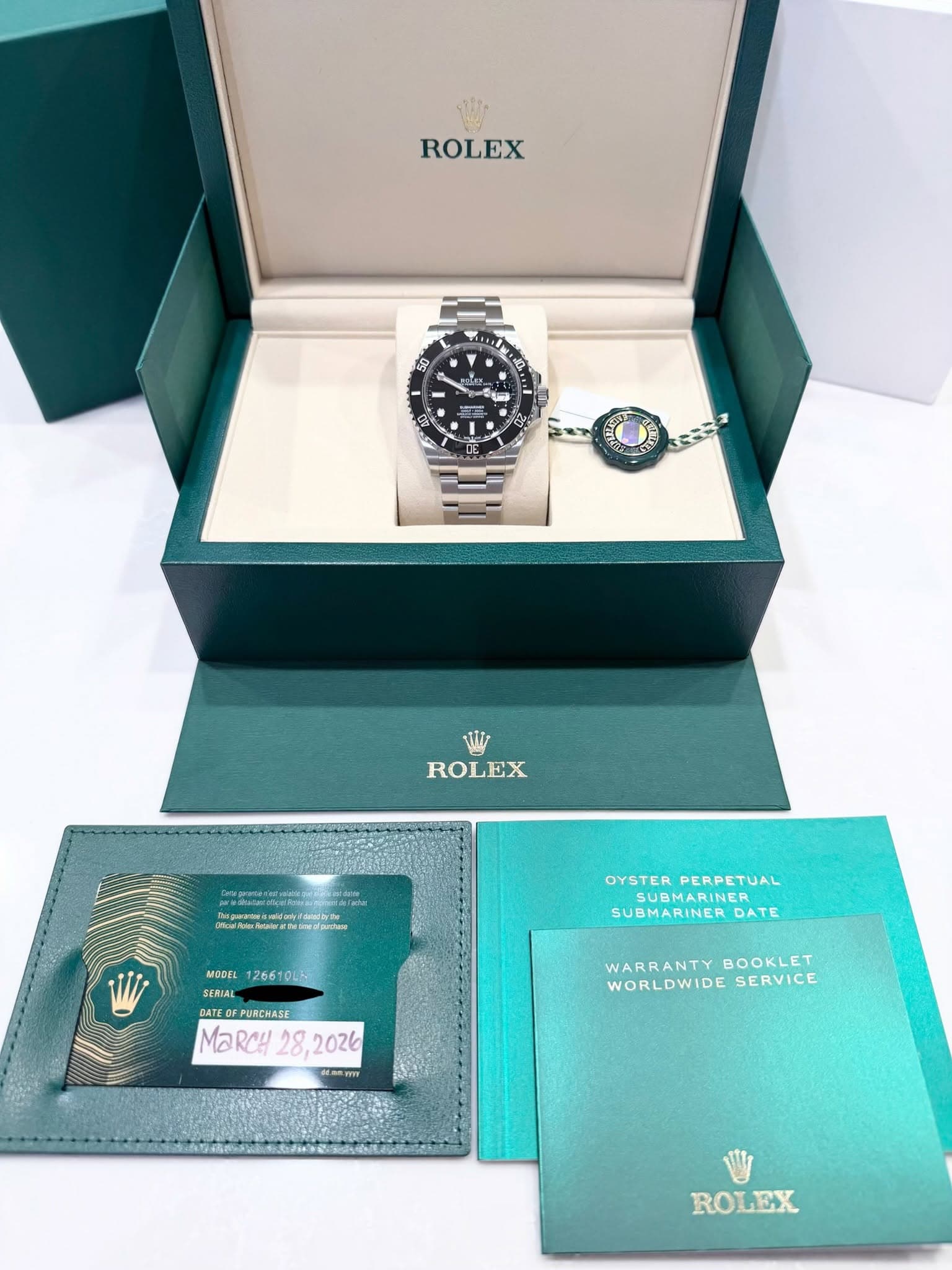 May be an image of wrist watch and text that says 'ROLEX ហ - - 变 ROLEX Aαma OYSTER OYSTERPERPETUAL PERPETUAL SUBMARINER SUBMARINER DATE MODEL 126610LH- SERIAL GATE GATE…